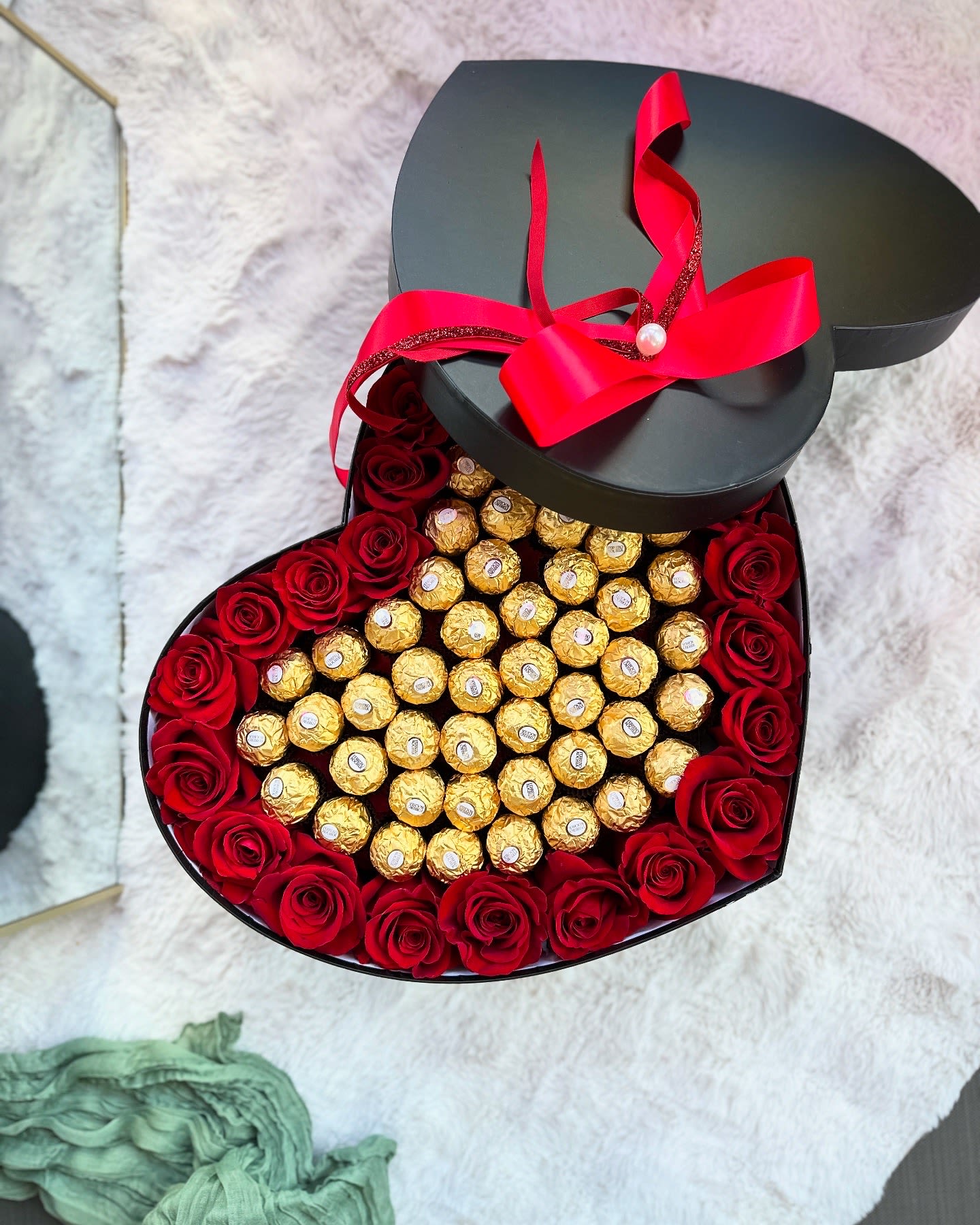 107P- Chocolate Heart - Beautiful combination of red roses and golden Ferrero Rocher chocolates in a heart shaped box. PREMIUM size is shown in the picture.