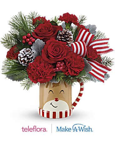 Teleflora's Send A Hug Reindeer Wish Bouquet - Overflowing with festive blooms, this adorable reindeer delivers your holiday wishes! The glazed ceramic mug adds a whimsical touch to your seasonal sipping. This delightful bouquet showcases red roses, red carnations, miniature red carnations, dusty miller, douglas fir, and white pine. It's beautifully presented in a Reindeer Wish Mug, perfect for spreading holiday cheer. This delightful bouquet showcases red roses, red carnations, miniature red carnations, dusty miller, douglas fir, and white pine. It's beautifully presented in a Reindeer Wish Mug, perfect for spreading holiday cheer.