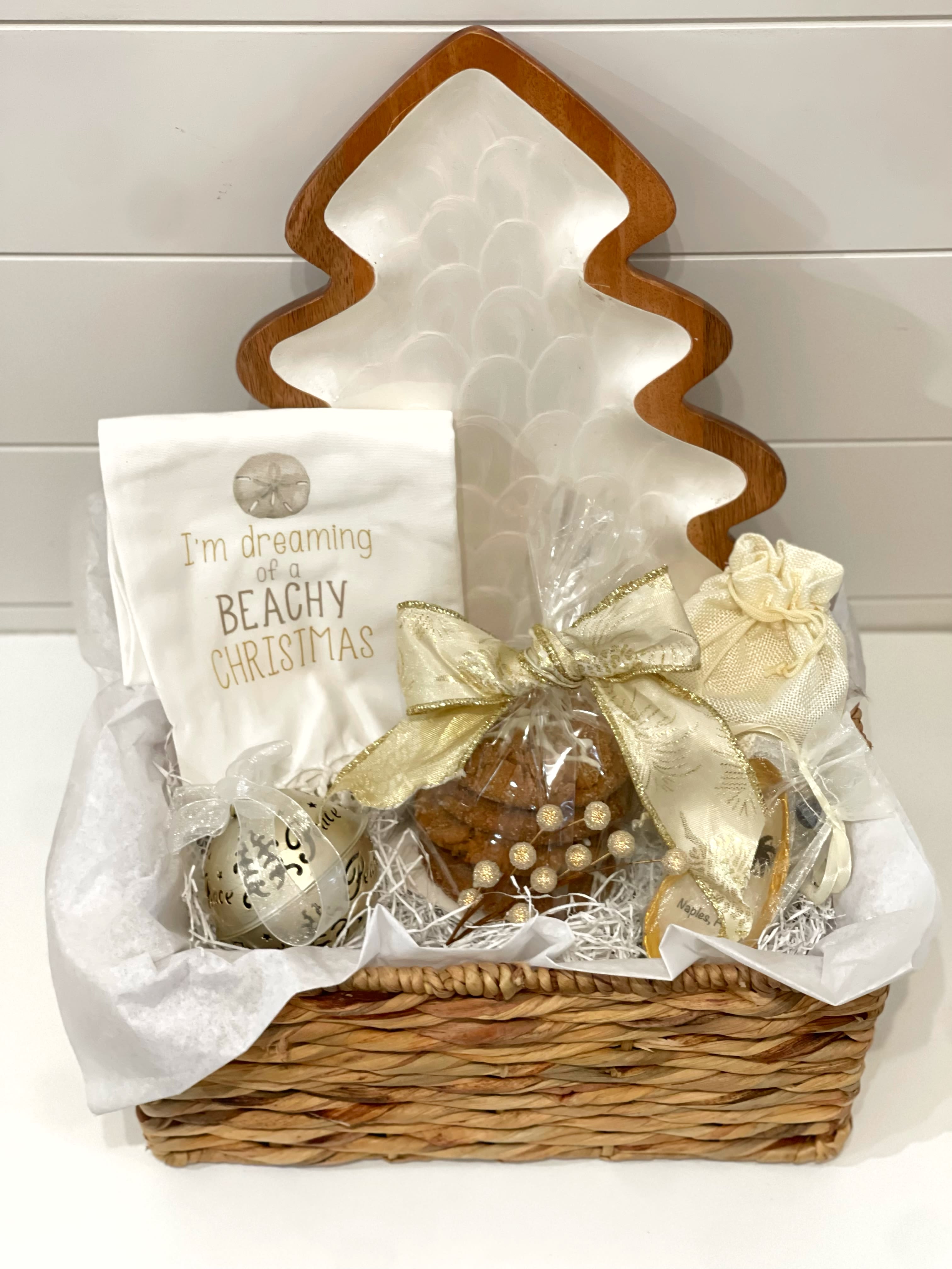 I’m Dreaming of a Beachy Christmas with Tree Platter - I’m dreaming of a beachy Christmas with tree platter: -Beautiful tree platter  -“ I’m dreaming of a beachy Christmas” kitchen, tea towel  -door jingle Bell ornament  -Fresh molasses Ginger  -Assorted chocolates  -Naples, Florida tree ornament, made by local artist  -in nice reusable wicker basket 