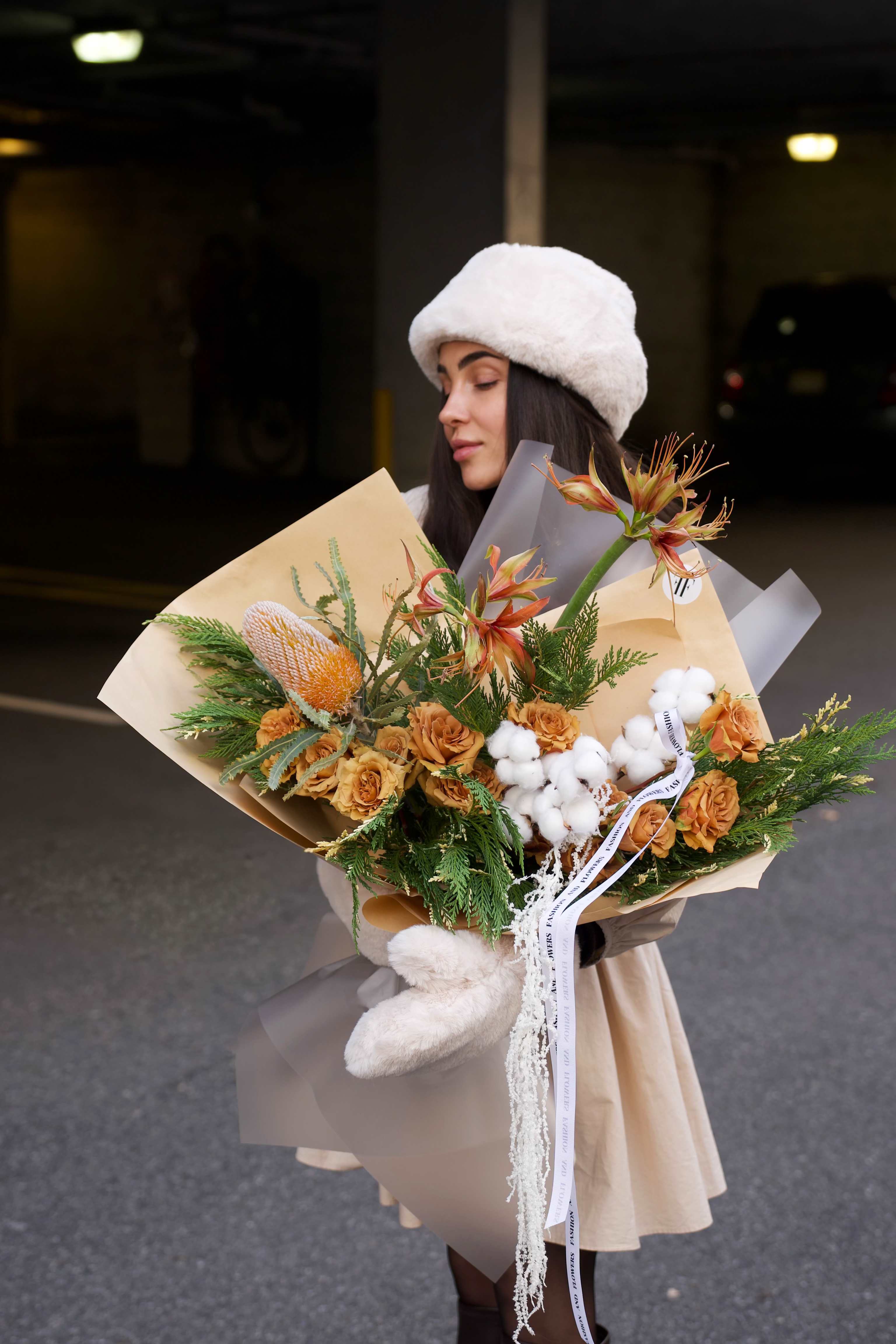 Caramel Cloud - Inspired by a winter fashion editorial, this modern arrangement features a warm caramel palette, sculptural lines, and rich seasonal textures.  Created with premium seasonal blooms, natural greenery, and soft cotton accents, this bouquet offers an elegant, contemporary feel. Designed in a vase and finished with our signature wrapping, it’s a refined choice for a stylish and thoughtful gift.  Vase included  Handcrafted &amp; one of a kind  Each arrangement is unique and may vary slightly.