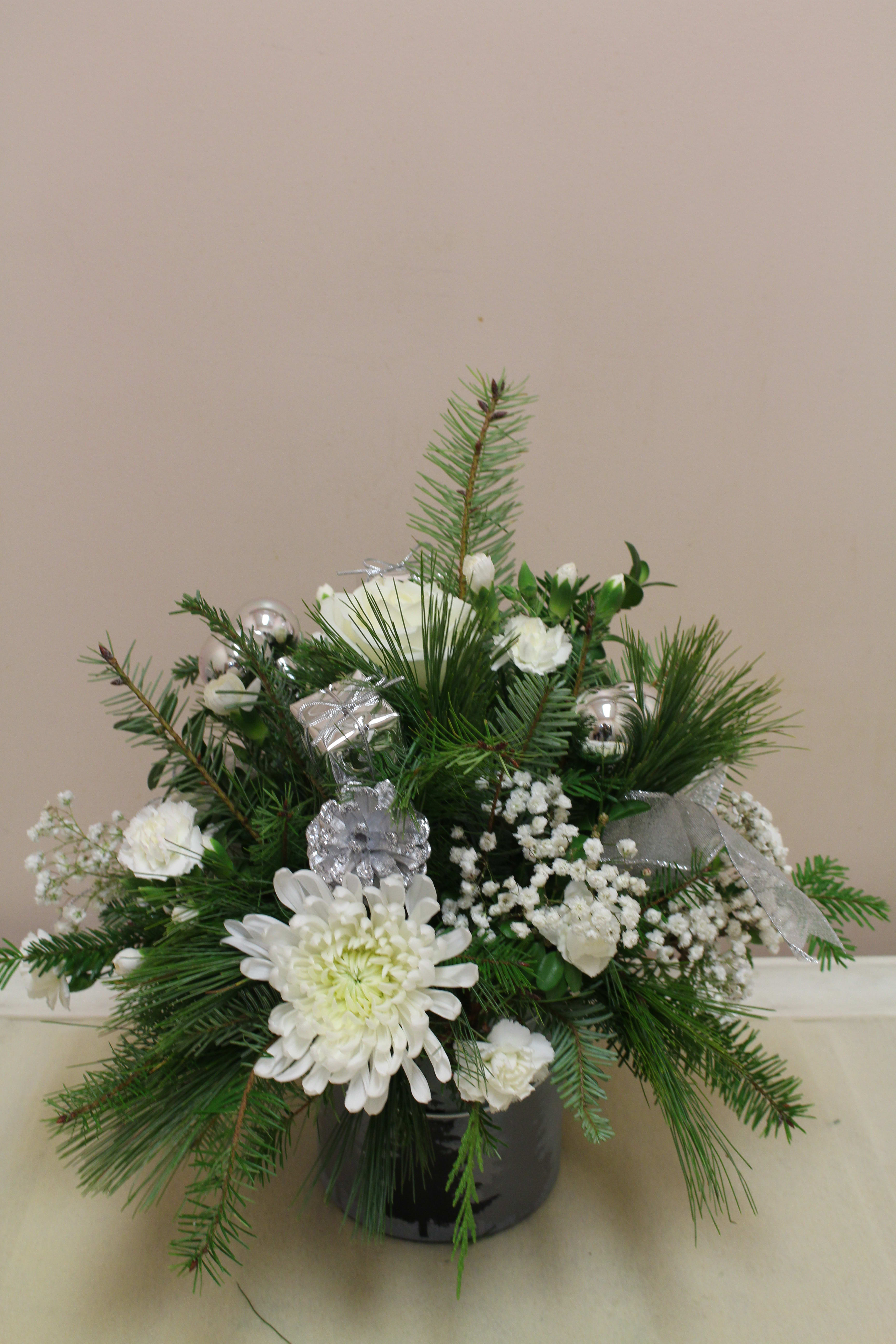 winter woods  - fresh arrangement with a winter woods scene.  filled with xmas greens and with flowers 