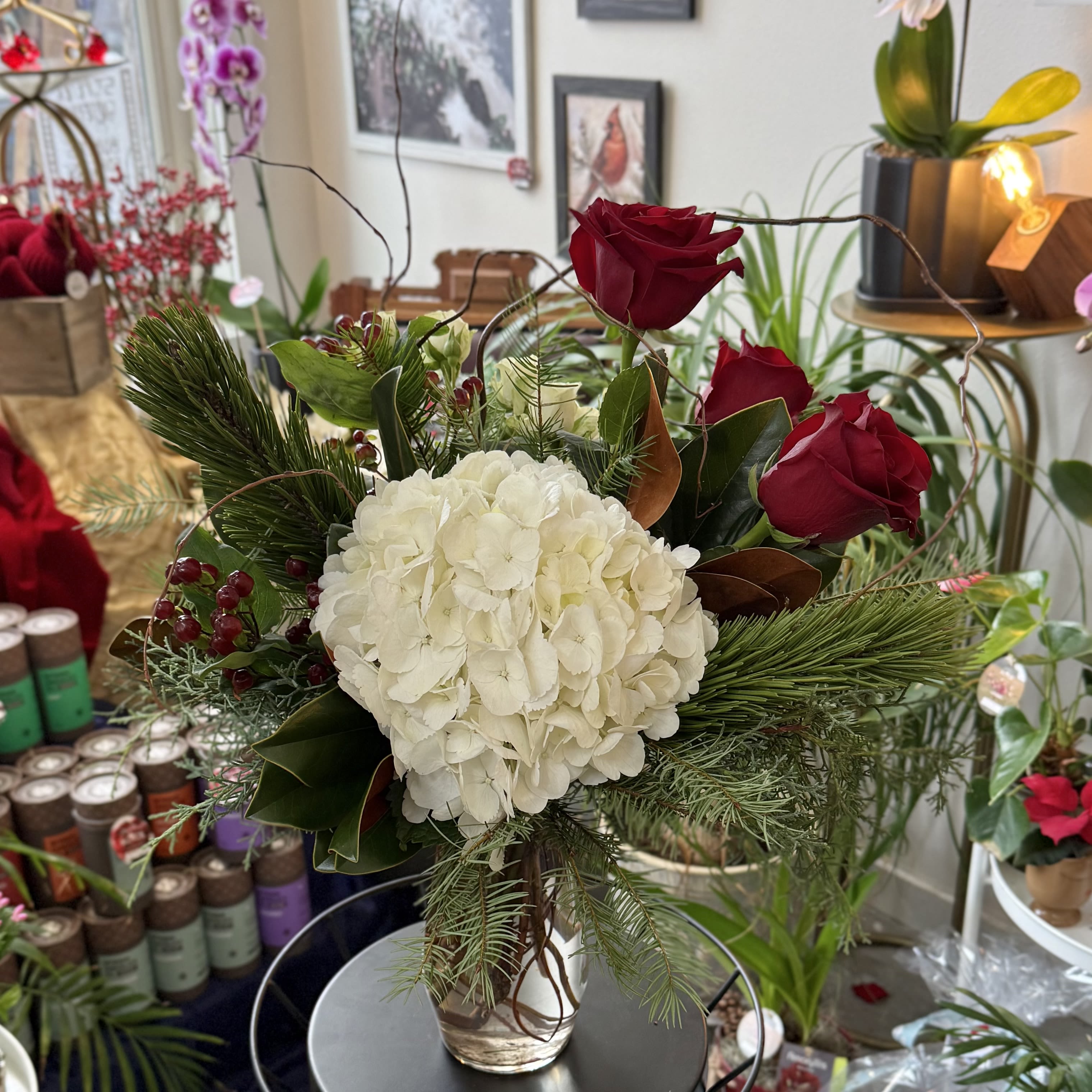 I'll Be Home For Christmas - A lush winter arrangement in a vase lined with curly willow. A promise of times together soon.