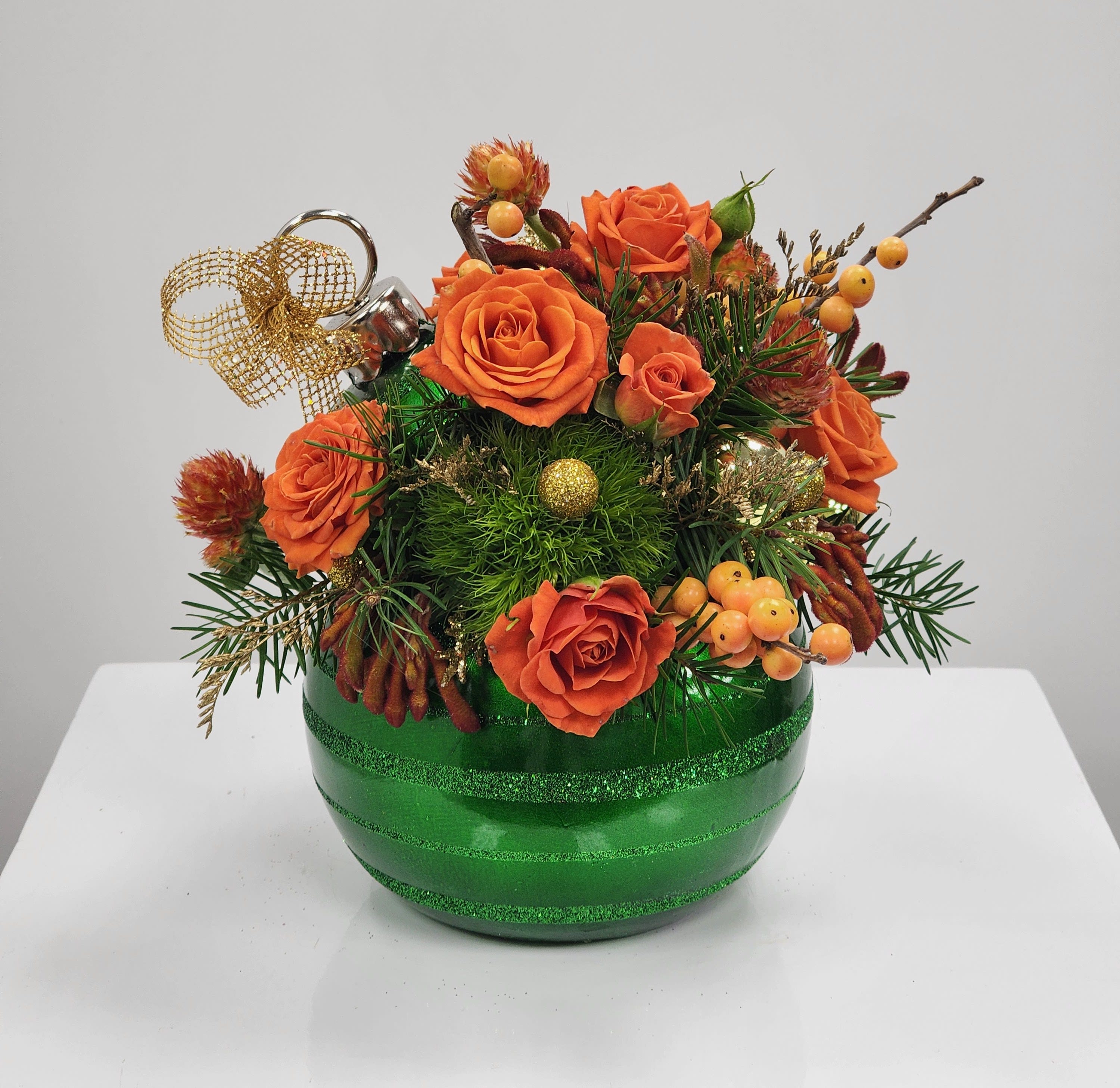 Merry Grinchmas - Select this mischievously fluffy and ornate green ornament arrangement. Filled with spray roses, kang paw, gomphrena, green trick, and ilex berries.  Approximately 8" tall and 7" wide.