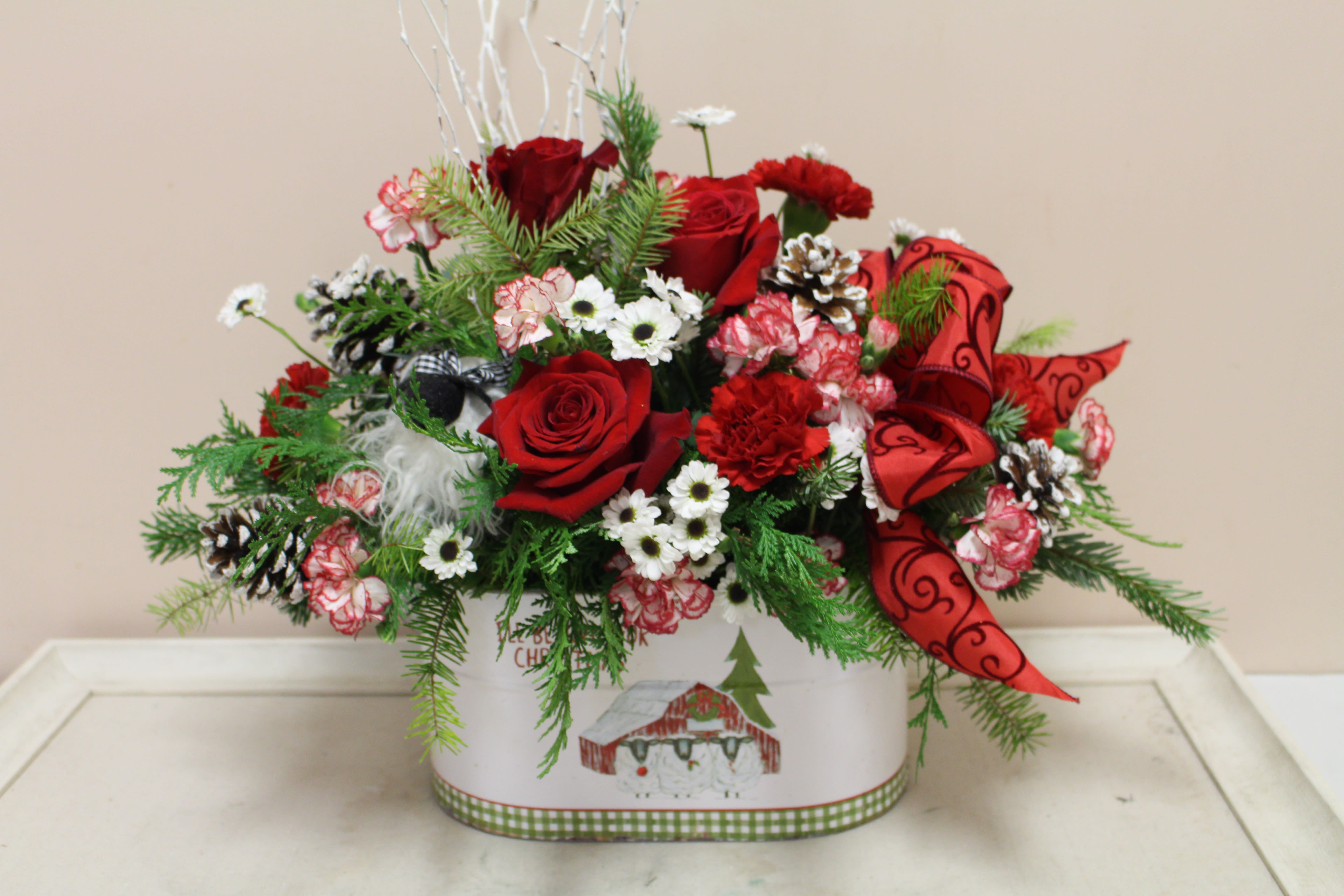 country farm christmas - you will see a little lamb peeking thru this beautiful arrangement.  The container has a farm scene that ties it all together!