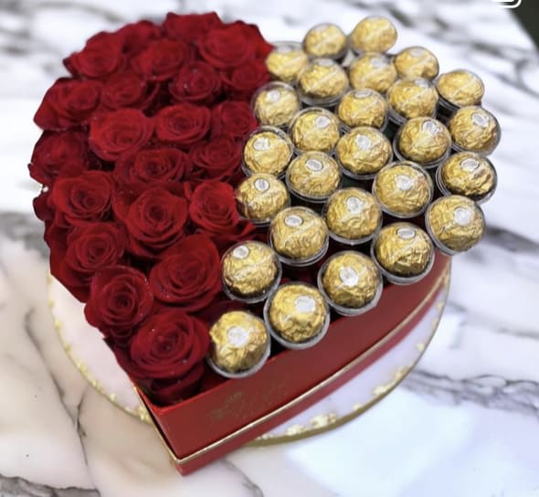Rose/Chocolate Heart Box - Doesn't Red Roses and Ferrero Rocher lift up the mood already by the sound of it? Imagine holding this piece of marvel in your hands, or better, theirs. Order this beauty and say it all this festive season. Availability Same day delivery available for order before 5 pm. Contains Red roses and Ferrero Rocher in Black Heart Box Disclaimer The number of flowers is an estimate in the case of a box or other container type arrangements as the actual number depends on the size of the flowers available on the day. However, the number falls in the range mentioned. 