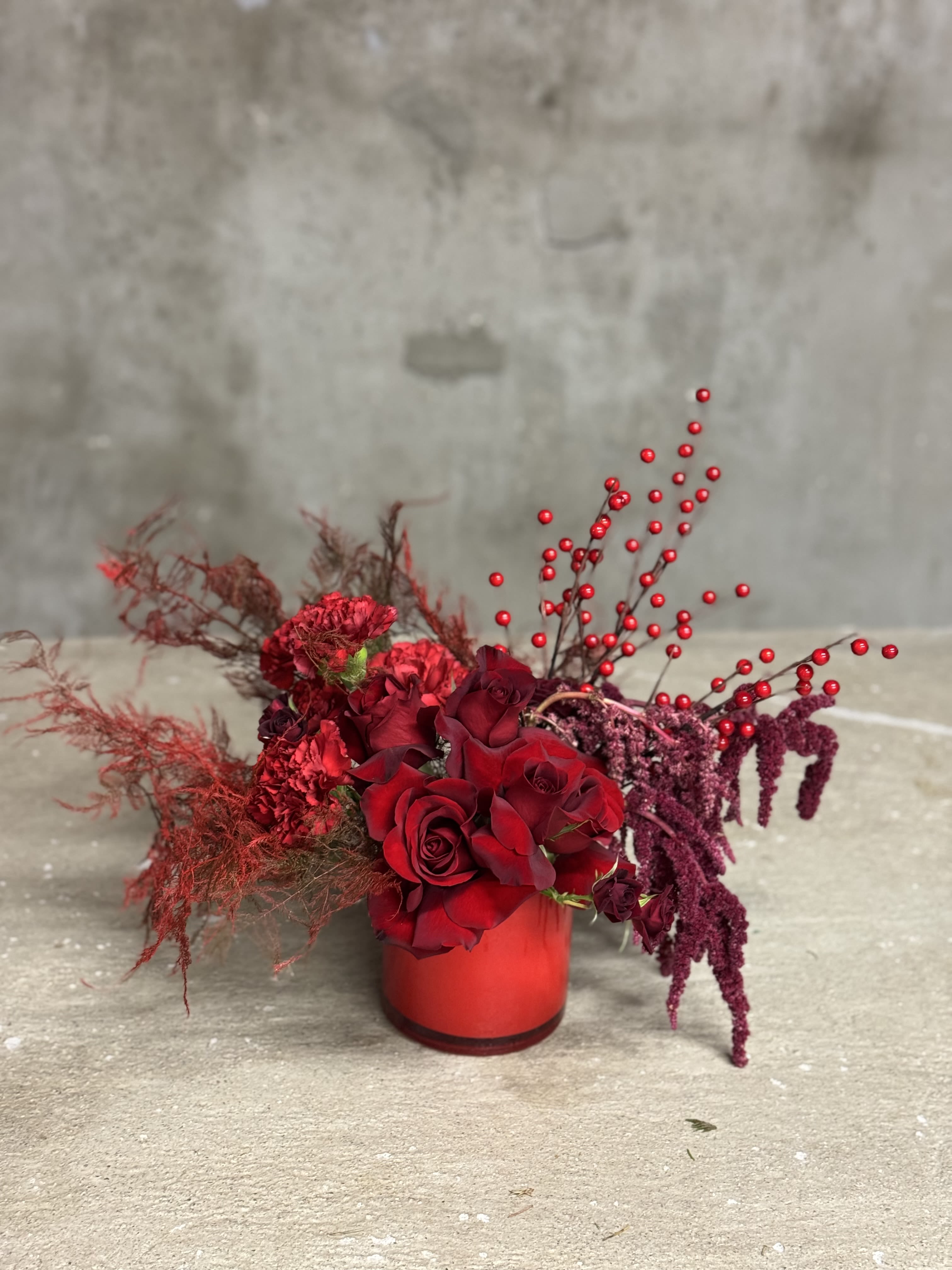 Christmas Á La Mode - Contemporary monochromatic Christmas arrangements for your table scape. Beautiful mix of red and burgundies.   Please note, this piece contains fresh and silk flowers. 