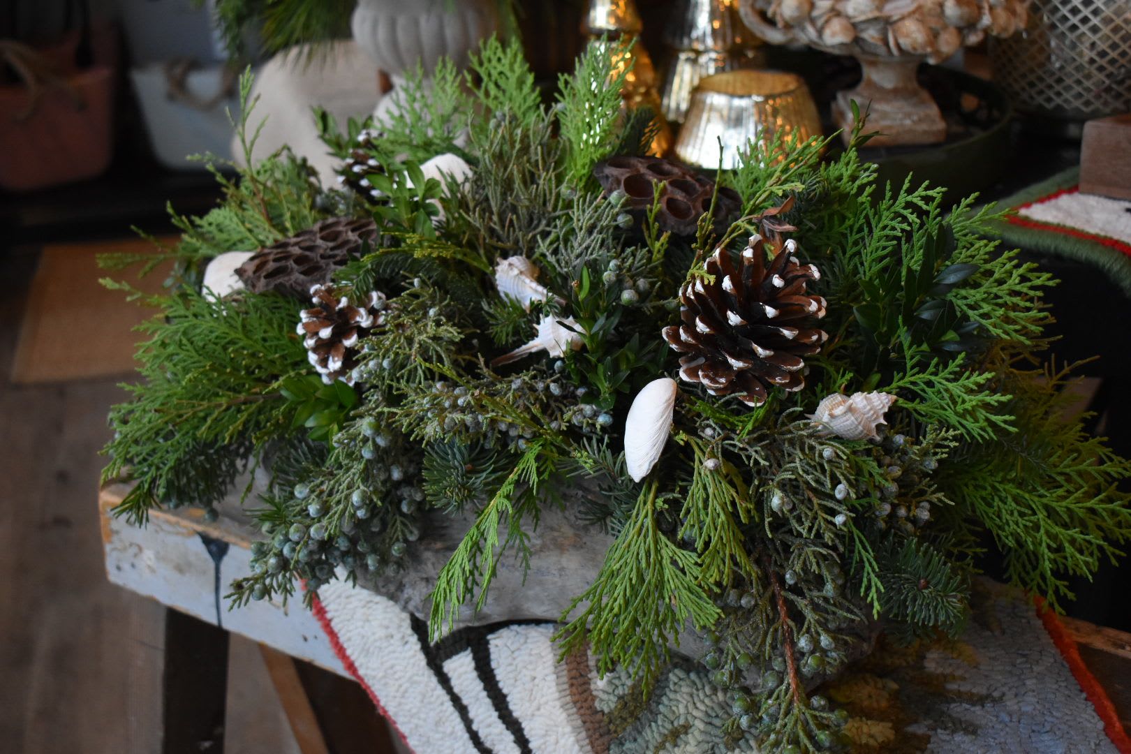 Harborside Greens - Enjoy an arrangement of evergreens in a luxurious birch container, with coastal accents perfect for any holiday gathering.