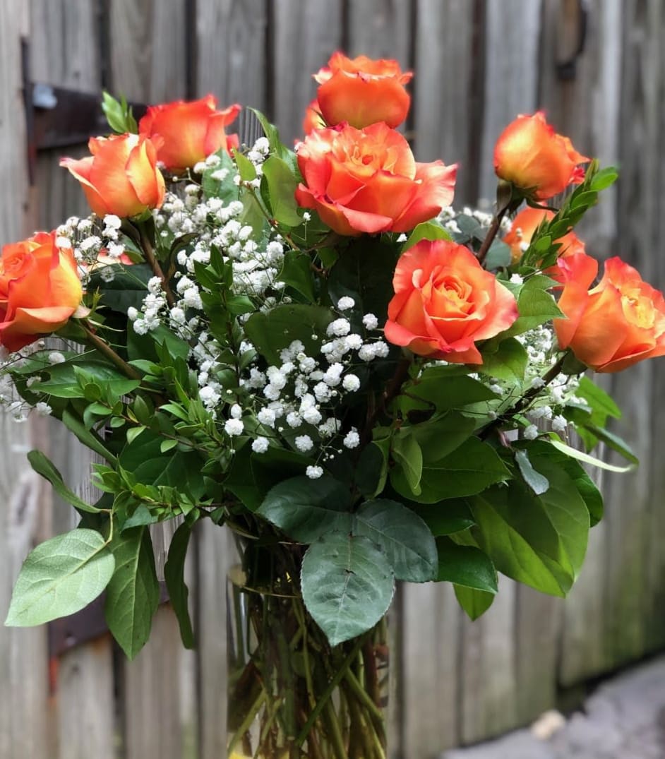 Orange roses in a vase - Full Dozen Orange roses in a vase: beautiful! Deluxe provides 24 stems and Premium 36. Upgrade to impress.