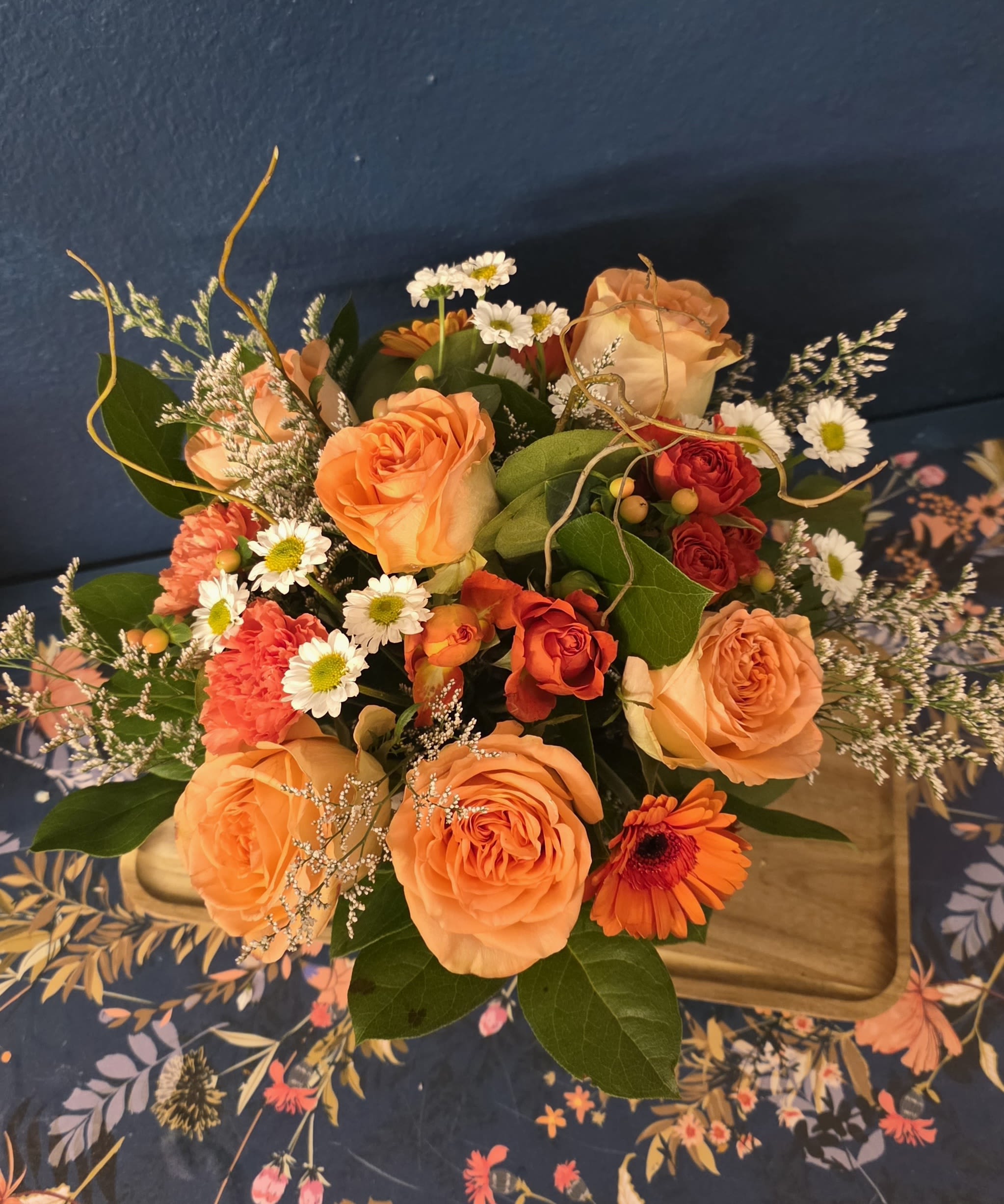 Britt's Bloom Box - Britt's Bloom Box features a rustic wooden box with an assortment of roses, carnations, seasonal blooms and greenery. Colors vary, so please specify if you have any color requests. Britt's Bloom Box comes in 3 sizes - 4" Standard, 5" Deluxe, and 6" Premium.   If you want to order all three sizes, please give us a call for a special price. 