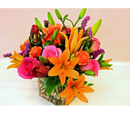 Precious Coral - W232  - Precious Coral is a cheery and colorful flower arrangement. This item is of modern design suitable for most occasions such as Birthday Get Well Bouquets Thank You gift and Just Because. Precious Coral by Fillmore Flowers San Francisco is a contemporary floral arrangement made with orange Asiatic Lilies pink and orange Roses red Tulips and purple Statice in a clear cube vase.Dimensions Approximately: 12&quot;H x 10&quot;W As Shown : W232 Flower Delivery in San Francisco Every day of the Year.