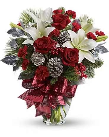 Holiday Enchantment Bouquet - Take your holiday gift-giving to new heights with this dramatic bouquet! Classic red roses, snowy lilies and naturally festive berries and pine are gathered in a tall arrangement they'll long remember. A lavish arrangement of red roses, white asiatic lilies, red carnations, noble fir, white pine, red berries, accented with silver pinecones and leaves. Finished with a rich red ribbon, this bouquet is dressed in holiday style.