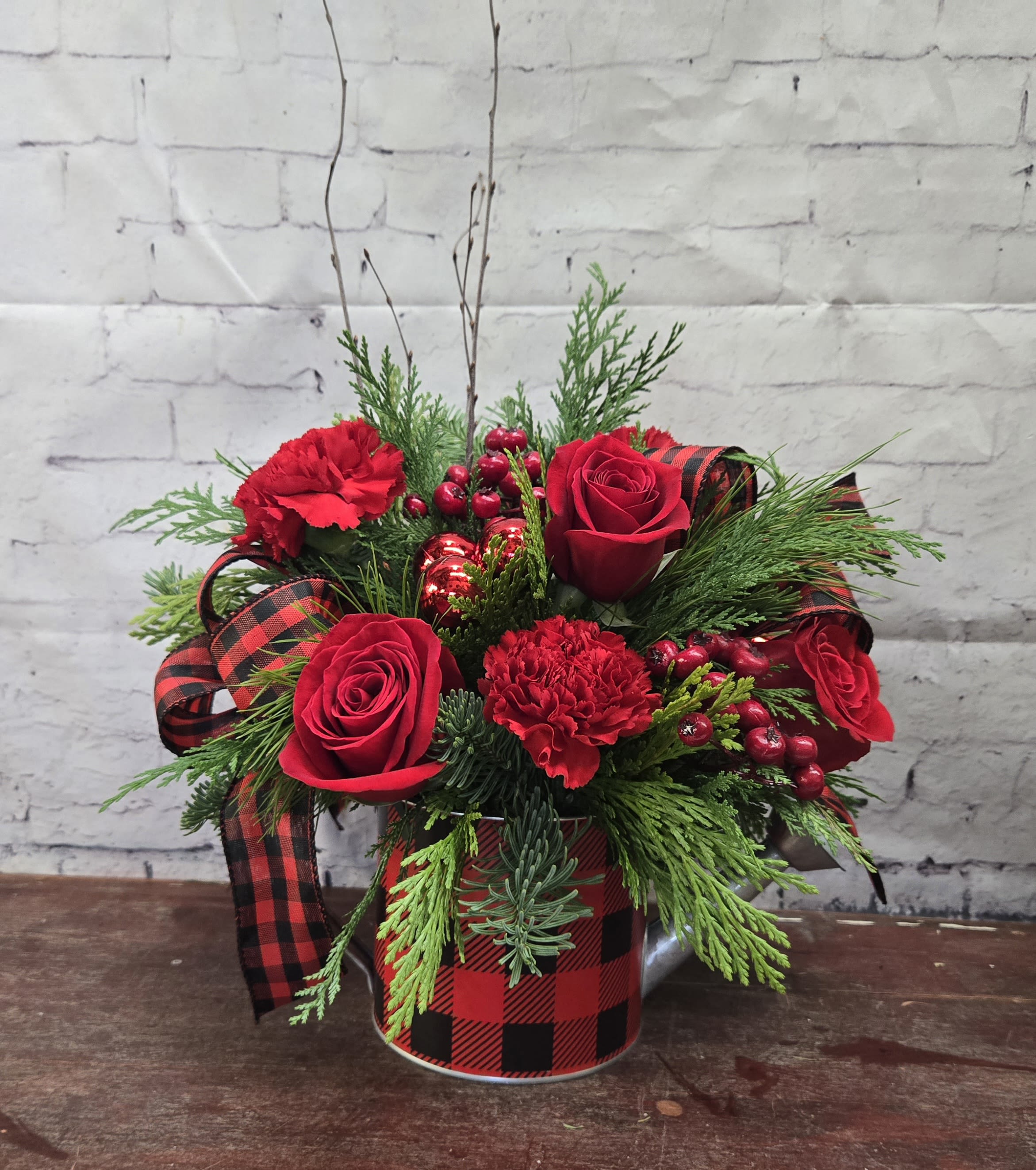 Rustic Cabin Christmas  - Black and red plaid watering can with evergreen and red roses and carnations.