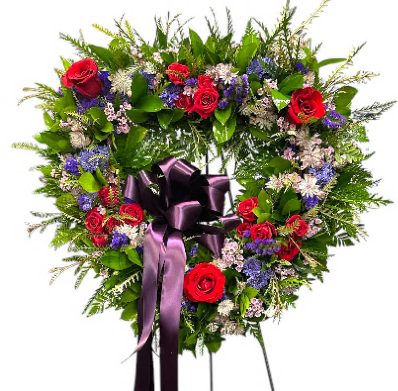 Magnificent Memorial Heart Easel  - The 18-inch heart-shaped sympathy easel is a beautiful tribute, designed with a delicate touch of nature that conveys heartfelt condolences. The heart is composed of soft and wispy flowers in lavender and purple that bring a sense of calm and peace. Combining these floral elements results in a serene and uplifting display, making it a perfect expression of sympathy and love during a difficult time. This easel can serve as a comforting presence at a memorial and a lasting reminder of cherished memories with the departed.