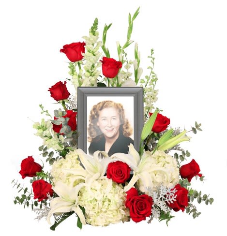 Missing You Photo Surround Tribute - The "Missing You Photo Tribute" arrangement is a heartfelt homage to cherished memories, elegantly blending the beauty of vibrant flowers with the soothing grace of foliage. Designed with timeless red roses symbolizing love and respect, and complemented by the purity of white snapdragons, gladiolus, larkspur, hydrangea, and lilies, this tribute captures both the sorrow of loss and the joy of remembrance. The lush green accents of baby blue eucalyptus, sword fern, and dusty miller provide a serene backdrop, highlighting the profound emotions associated with losing a loved one. This exquisite arrangement serves not only as a visual celebration of a life well-lived but also as a comforting presence during difficult times, inviting reflection and honoring the special bond that will forever remain.