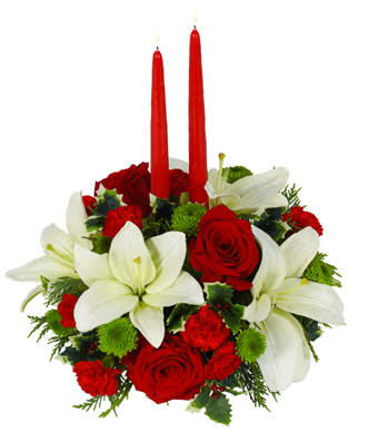 christmas center piece  - As friends and family gather around the Christmas table, they're sure to be delighted by this wonderful centerpiece featuring white Asiatic lilies, red roses, red mini carnations and green button poms. A pair of 12-inch red taper candles adds to the celebratory mood.