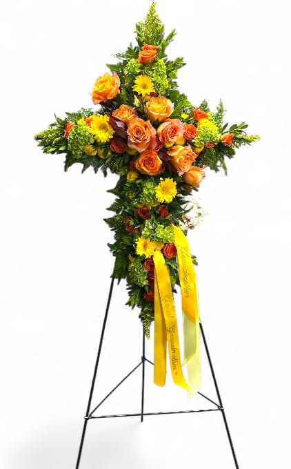 Summer Memories Cross Easel  - This striking floral display features a beautifully crafted cross easel adorned with a vibrant and diverse selection of blooms. The arrangement showcases radiant Solidago, complemented by bright orange spray roses, cheerful yellow mini gerberas, and delicate yellow buttons that add texture and warmth. Green hydrangea provides lush fullness and a touch of elegance, while yellow leather myrtle introduces rich greenery and subtle color contrast. The combination of these elements creates a heartfelt and uplifting tribute.
