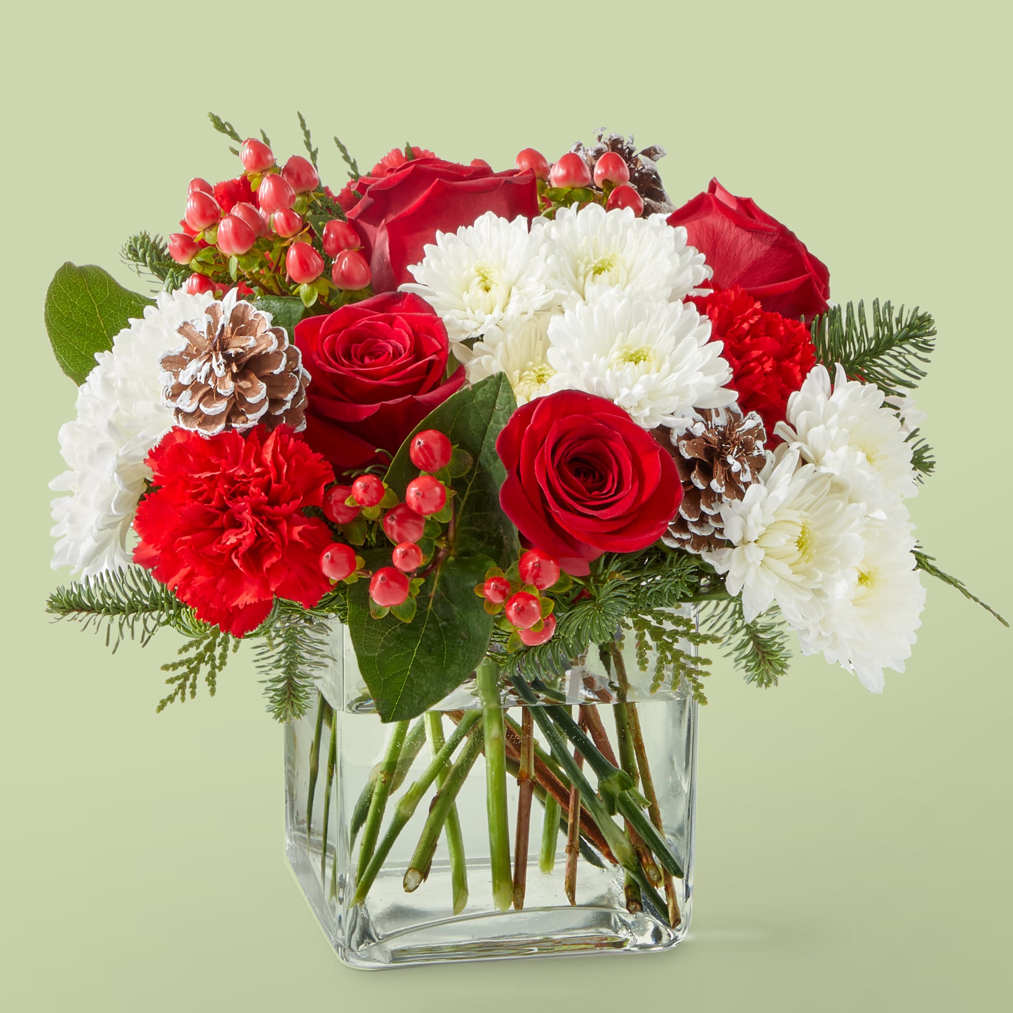 Snow Angel Bouquet - A delicate balance of red and white florals accented with seasonal greens to brighten their day. approximately 10&quot;H x 11&quot;W.