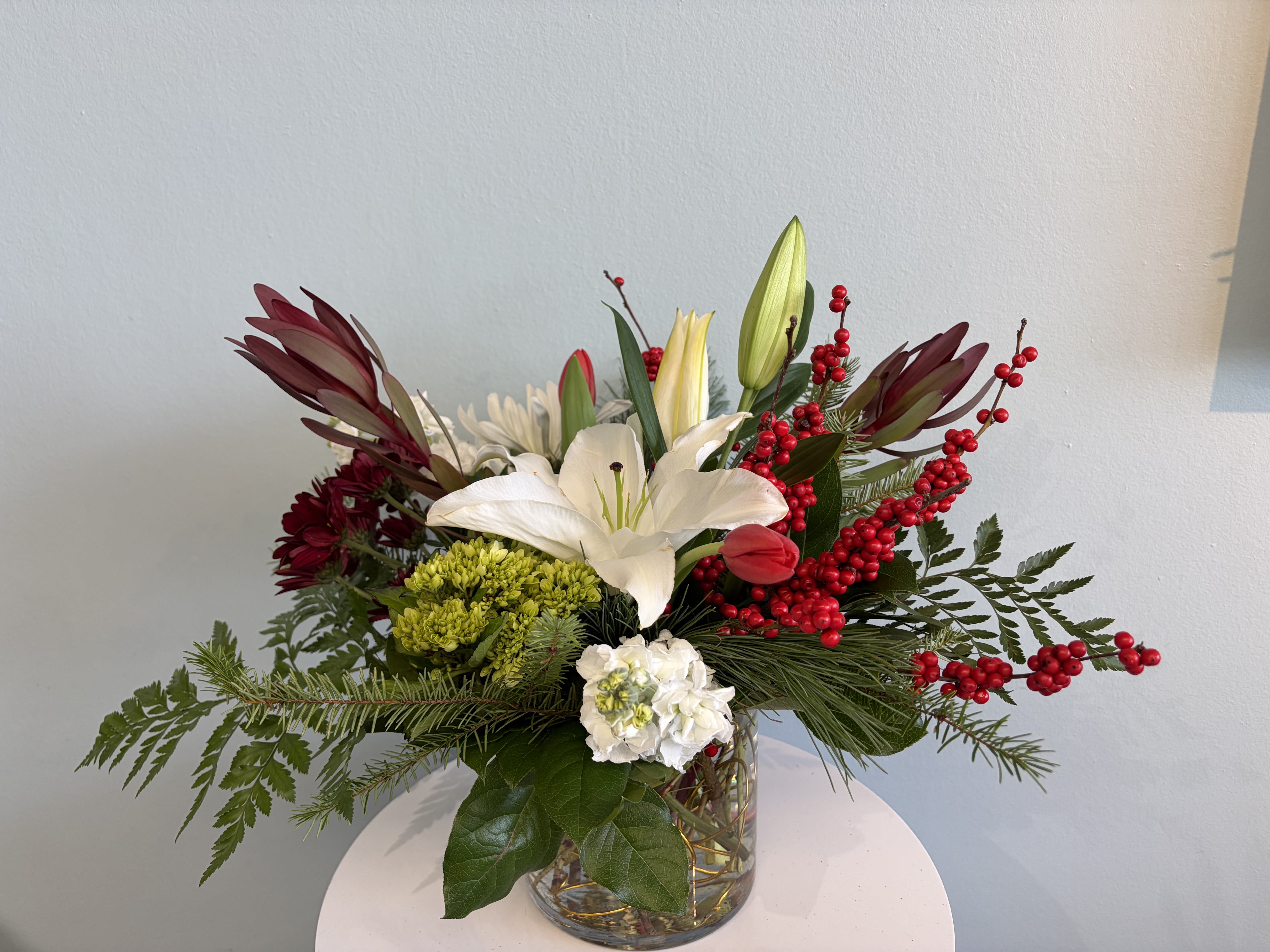 Christmas Centerpiece #4 - A festive Holiday Centerpiece for your table! This centerpiece will include a mix of red, white, and green blooms that are perfect for the Holiday season!