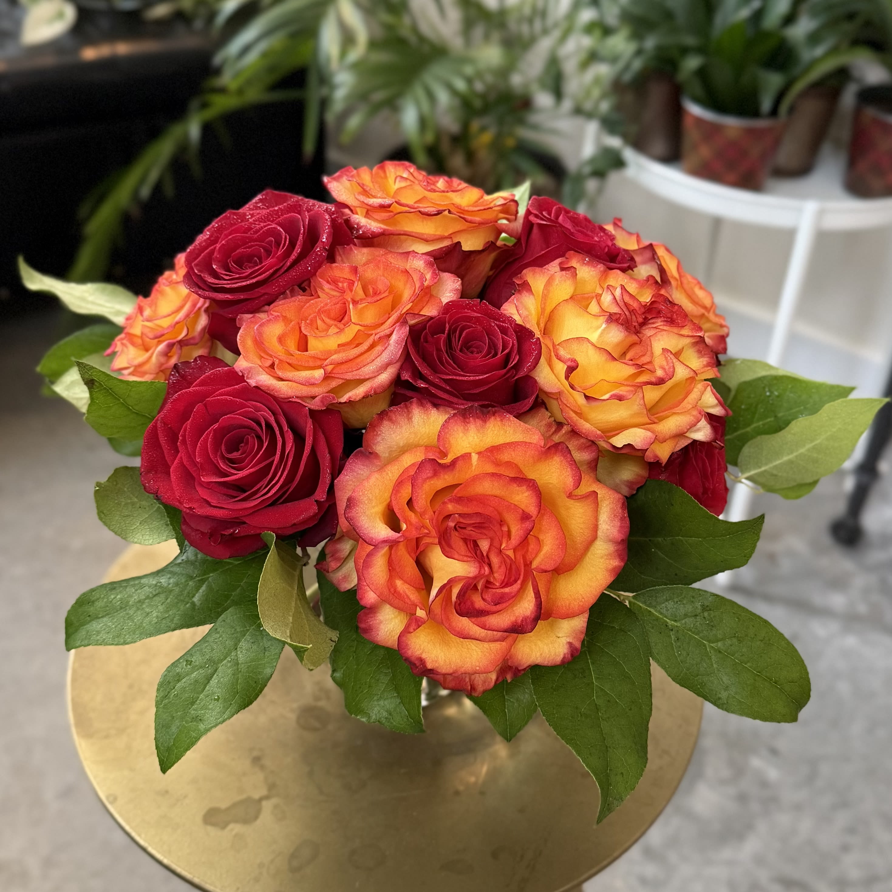 Falling Leaves - One dozen richly autumn colored roses, gathered in a fluted ivy bowl with premium greens.  An elegantly tasteful design.