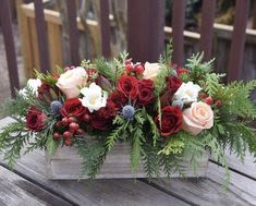 Winter Wonderland - Evergreens with fresh flower in a low wooden container.