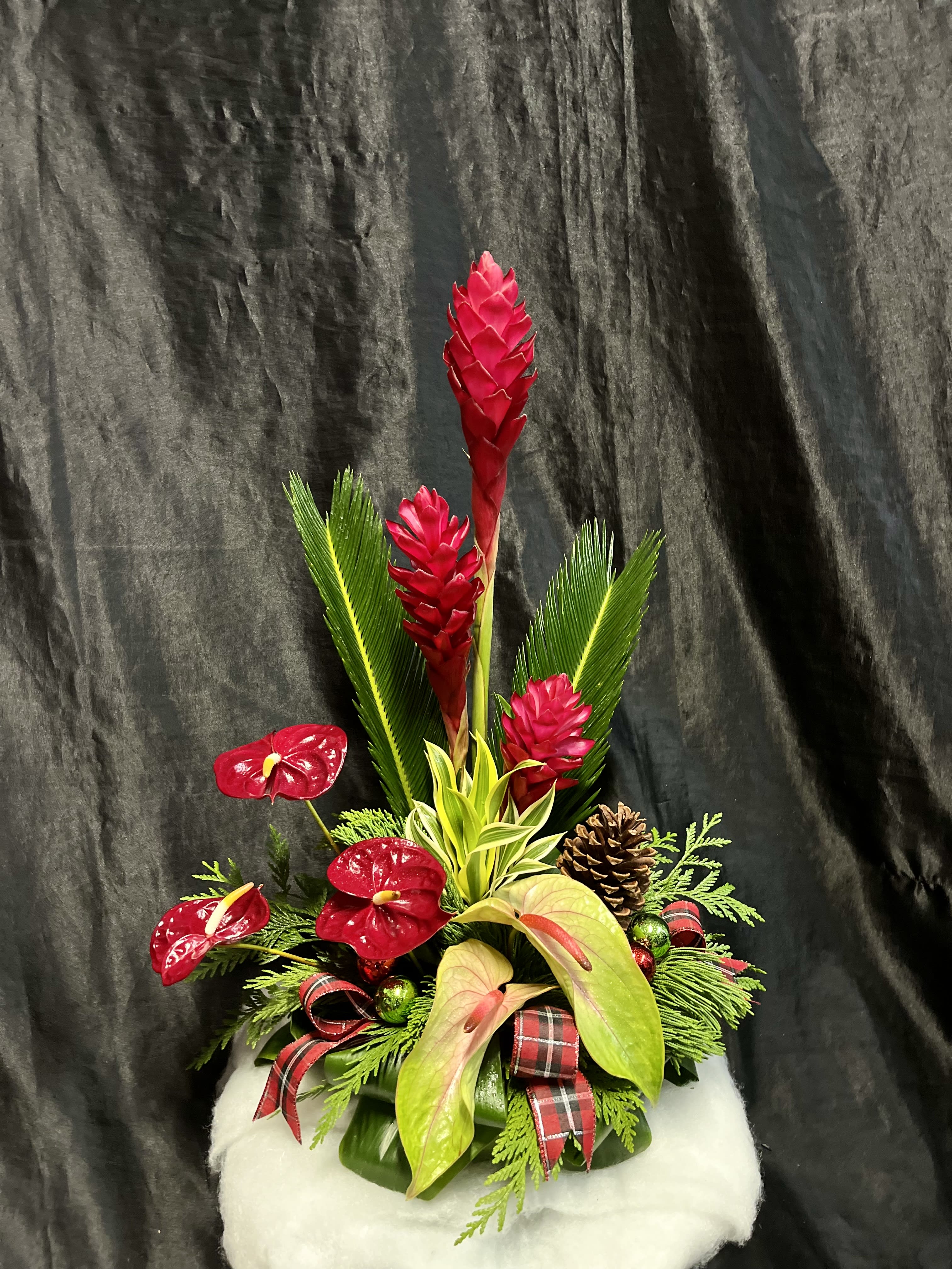 Christmas Tropical Arrangement  - A holiday twist on one of our classic medium tropical arrangements!  This is made up of a variety of available tropical flowers, Christmas foliage and holiday cheer! 