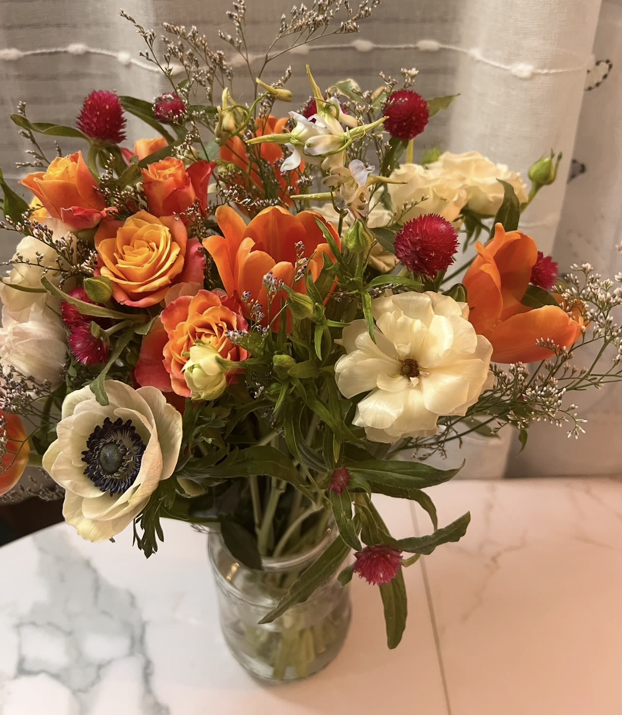 Honeyed Blush  - A sweet yet sophisticated arrangement of honey-toned roses, soft ivory blooms, and delicate seasonal accents. Honeyed Blush is airy, charming, and effortlessly elegant—designed to feel warm, inviting, and beautifully refined. 