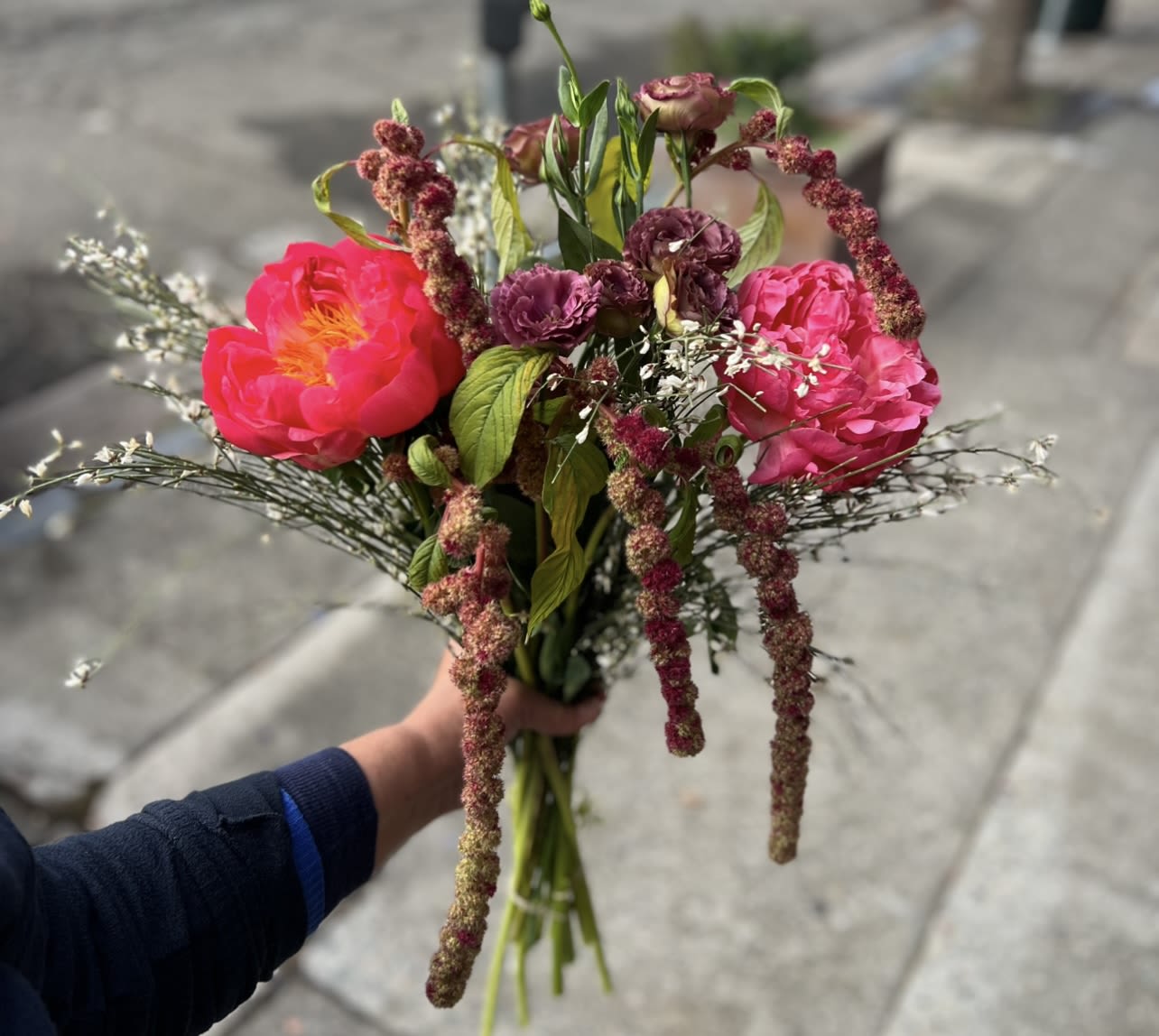 Petal at Dusk  - Inspired by fading light, Petals at Dusk blends luminous coral blooms with deeper, moody florals and airy accents. This bouquet feels intimate and expressive—romantic without being traditional. 