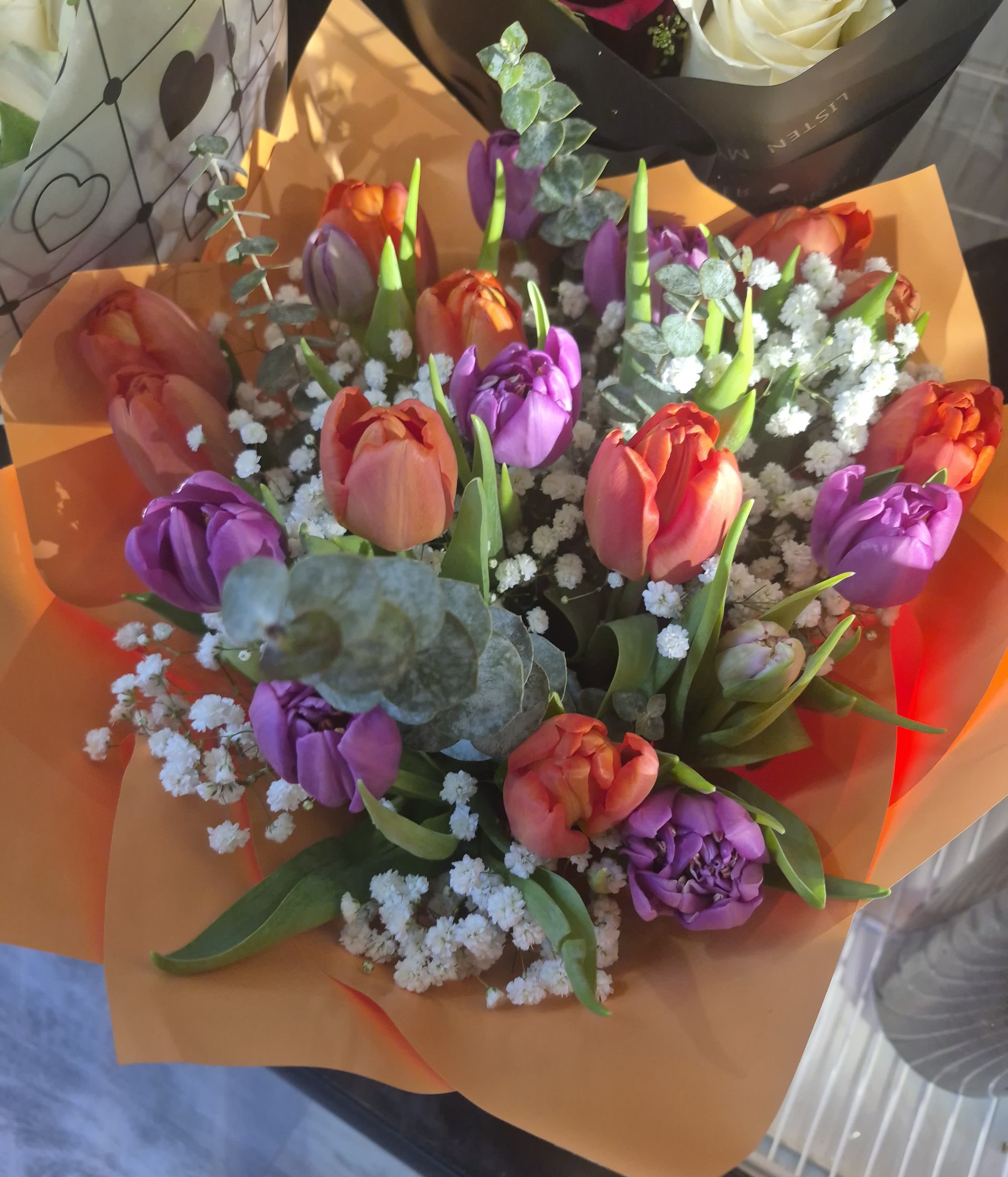 Spring Whisper - The Spring Whisper arrangement, a beautiful promise of new beginnings and gentle affection. Soft shades of pink, purple, and white, featuring delicate tulips and roses, create a charming, serene display. It's the perfect way to bring the freshness and elegance of springtime indoors.