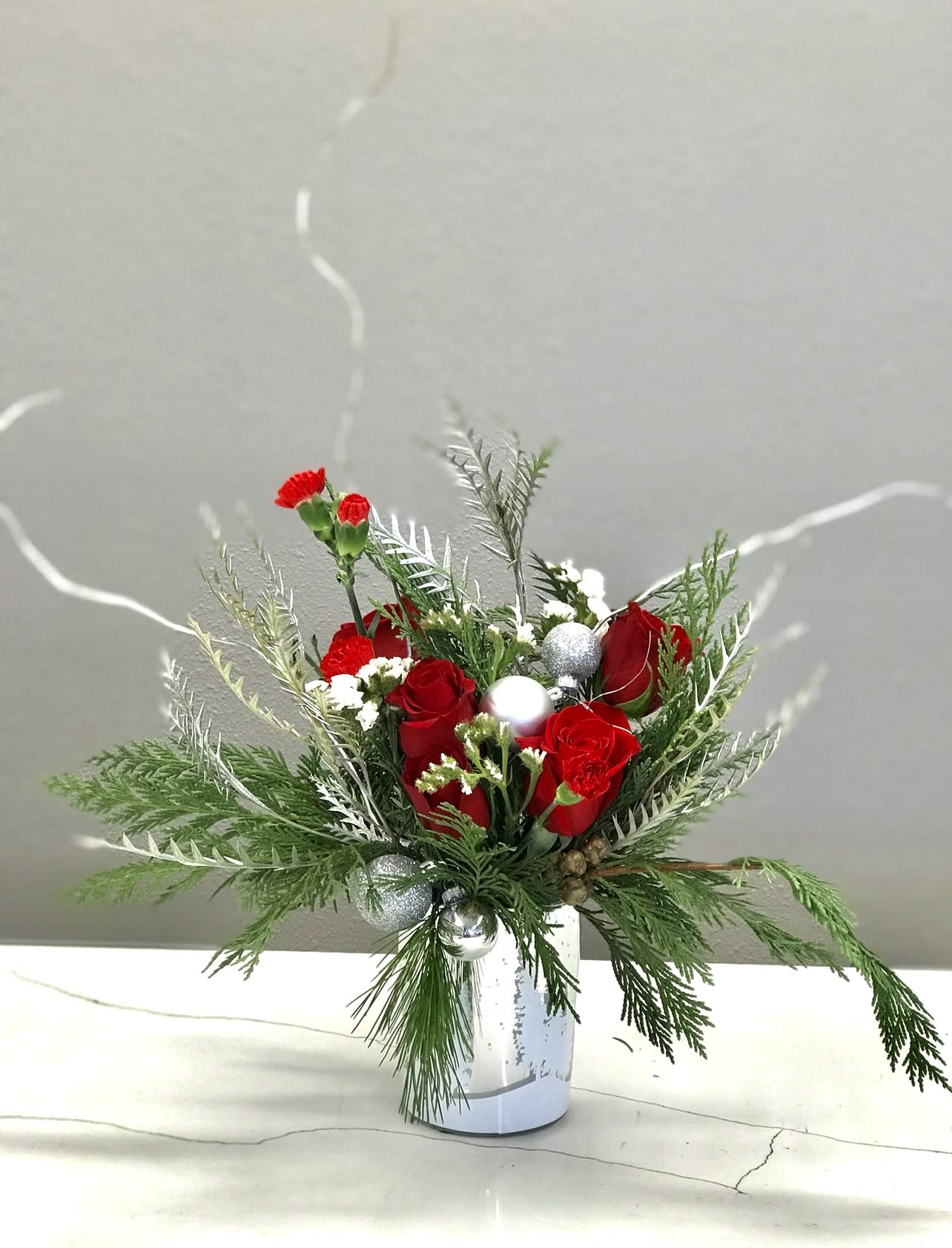 Christmas Celebrations - Capture the romance of the season! wonderful red and white flowers fill our stunning silver glass vase .