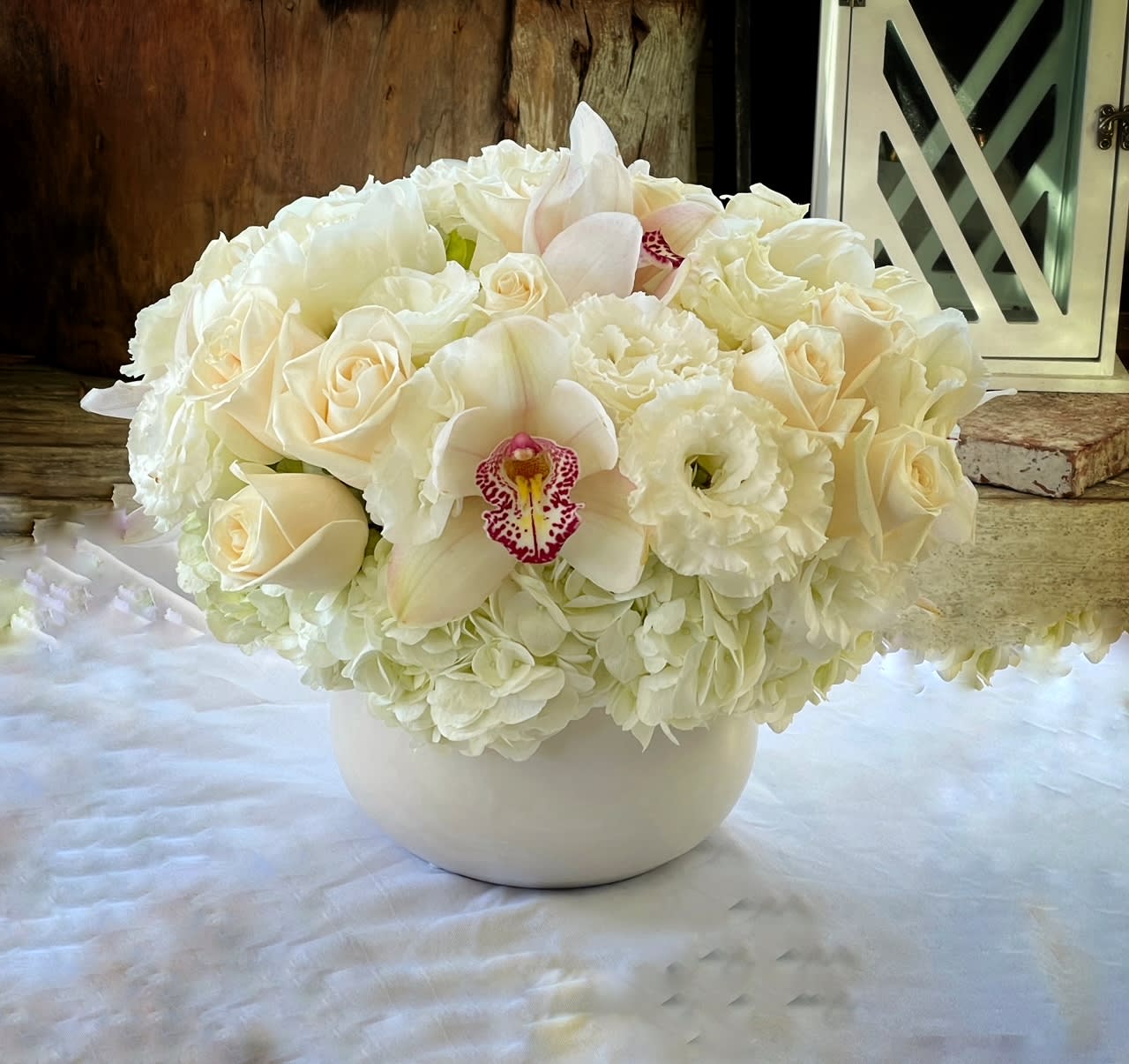 Rudolph  - Premium Roses, Hydrangea, Lisianthus, Cymbidium Orchid,... in white ceramic vase.