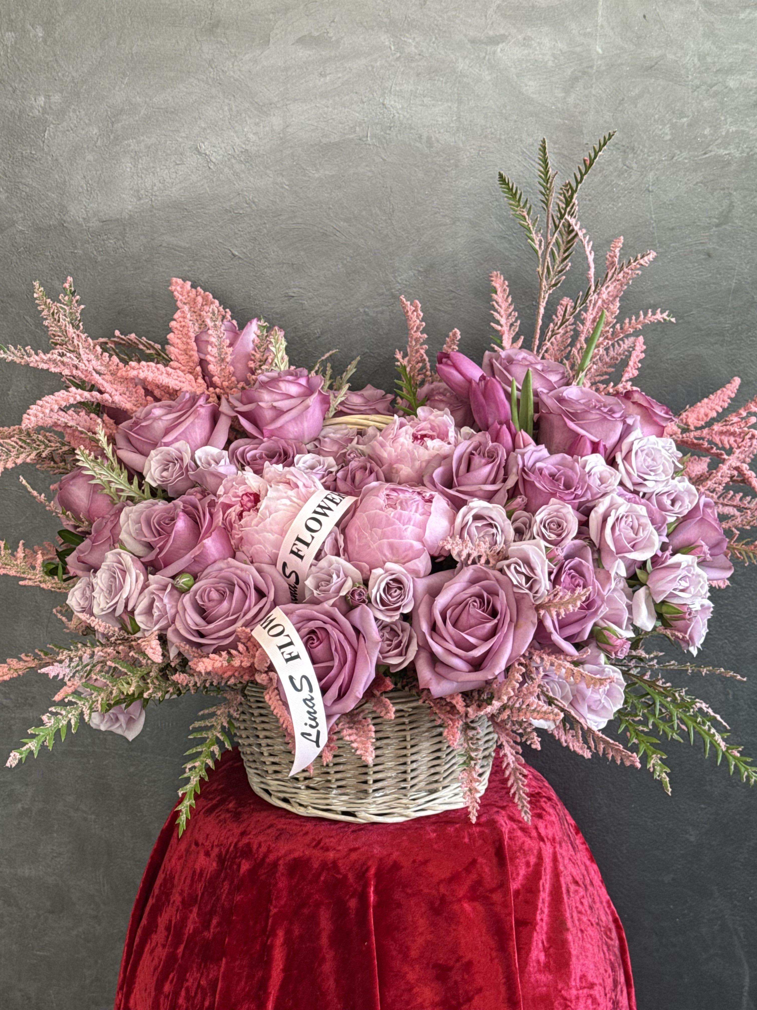 Bella - Purple roses and soft pink peonies gracefully arranged in a charming basket — a romantic blend of elegance, tenderness, and timeless beauty.