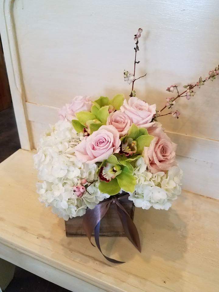 Lime Sorbet - Designed in a rustic box, filled with crisp hydrangea, soft hues of pink/peach roses and lime green cymbidium orchids. 