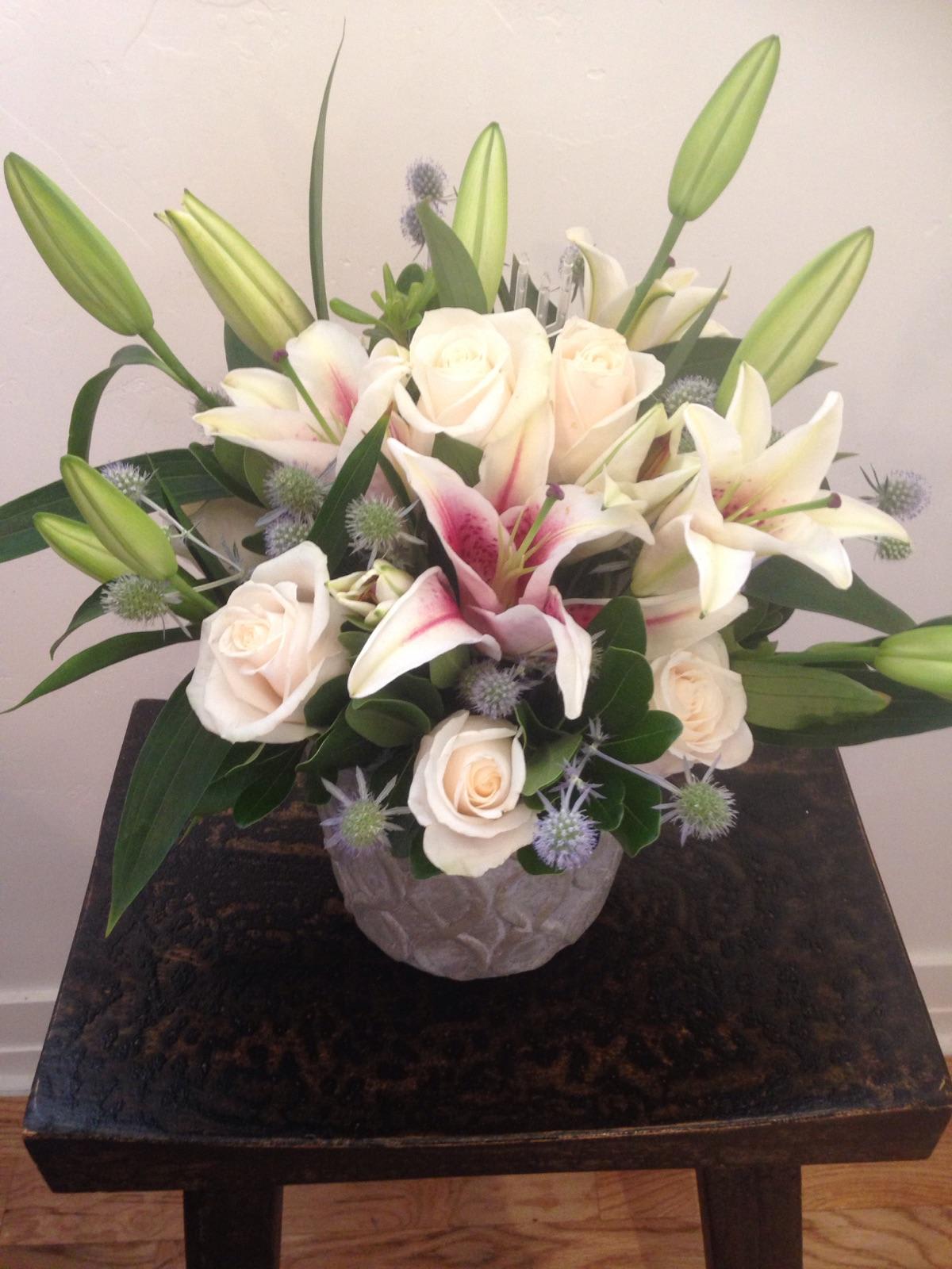 Sweet Serenity - Crisp white roses, stargazer lilies and a pop of eryngium. 