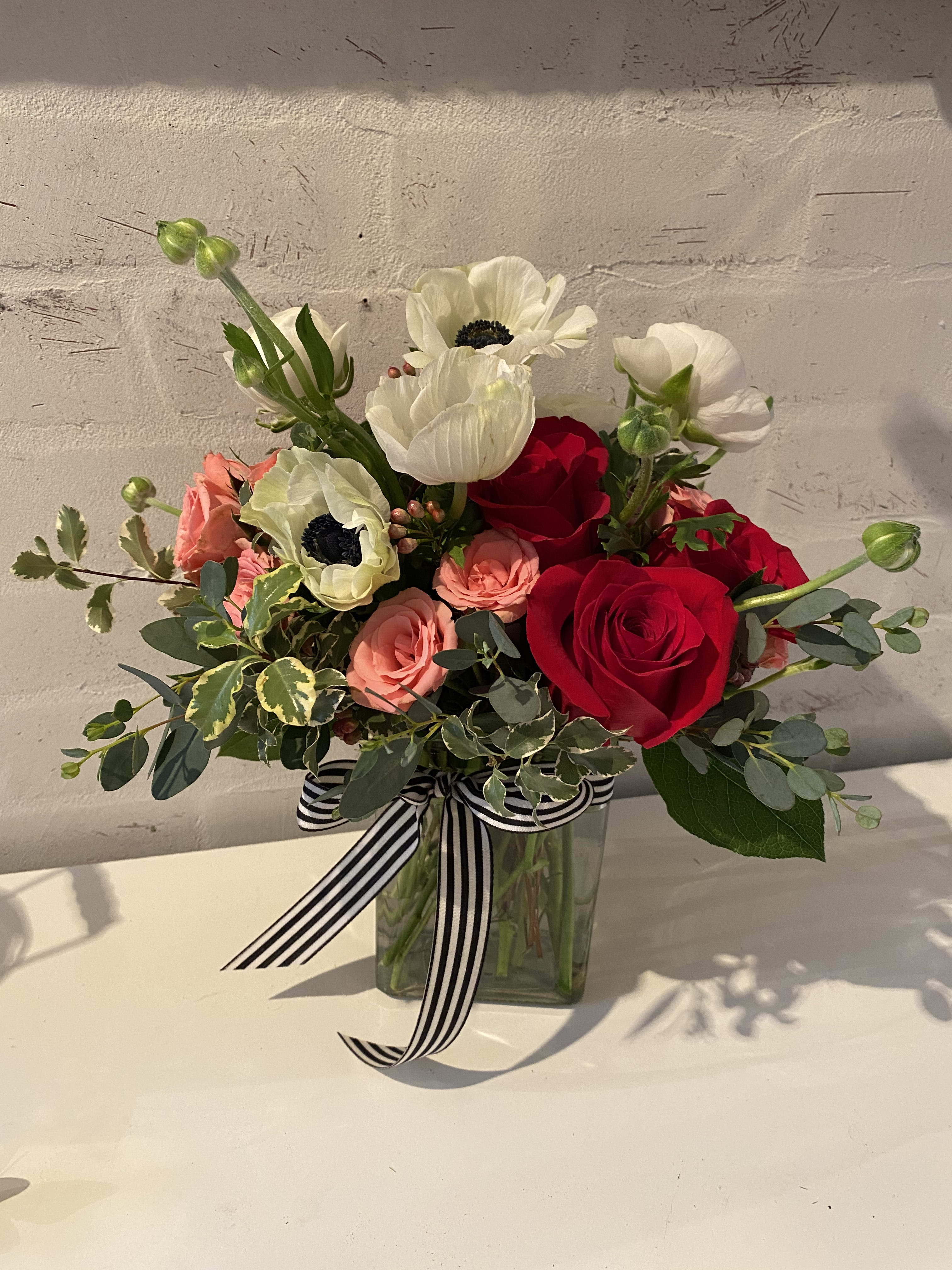 Endless Love - A sweet little arrangement with big impact filled with Red roses, pink spray roses, ranunculus and anemones. 