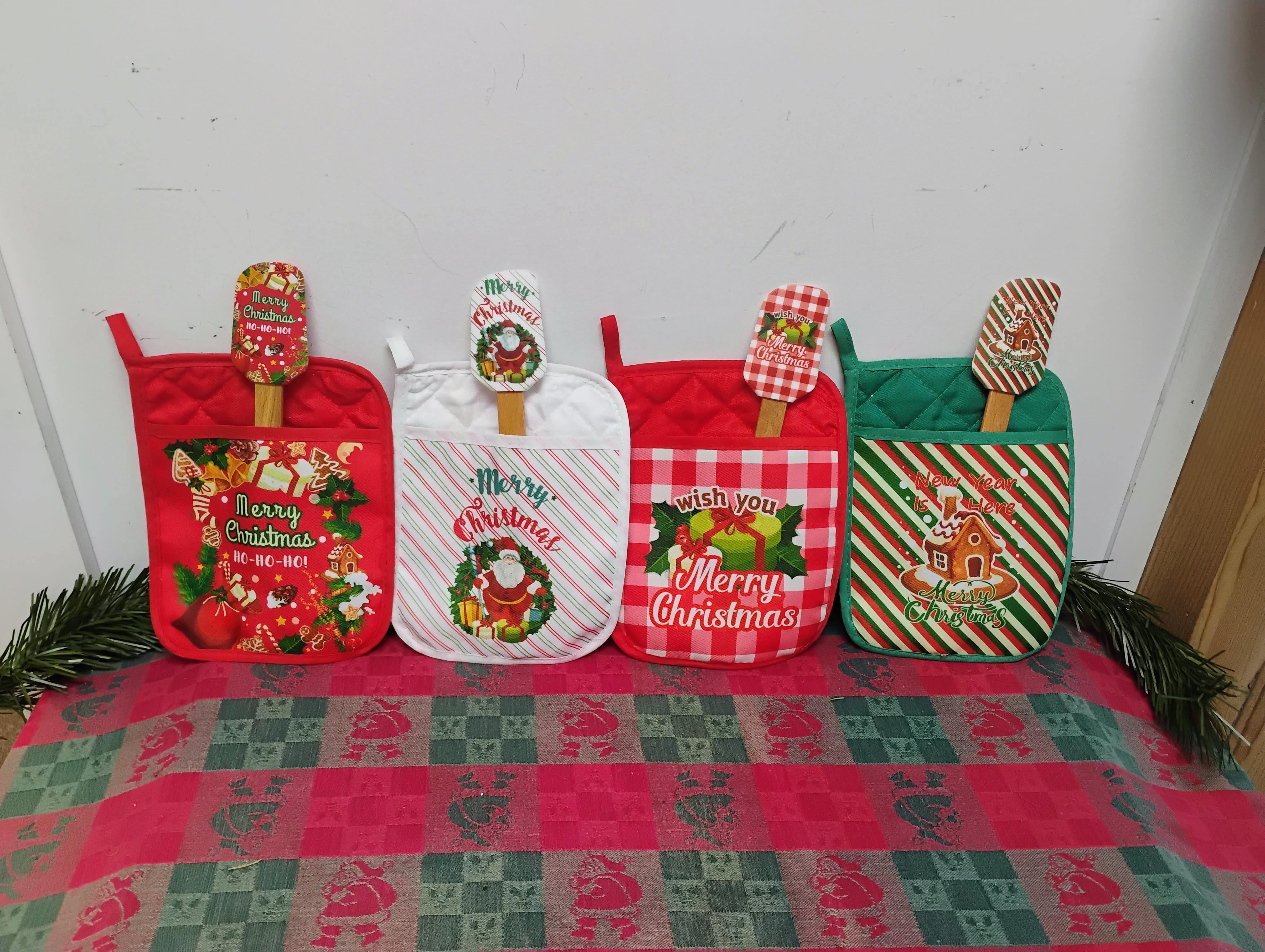 Holiday Heat &amp; Treats Set -  Spice up your seasonal baking with this festive kitchen duo! Each set includes a heat-resistant pot holder and a matching silicone spatula, decked out in merry prints like gingerbread houses, Santa stripes, and cozy checkers. Whether you're whipping up sugar cookies or stirring up cocoa, these cheerful companions bring warmth, whimsy, and a dash of holiday magic to your kitchen.   Includes one pot holder + one matching spatula    Four collectible designs—mix, match, or gift!    Durable, flexible silicone spatula for all your stirring and scraping needs    Pot holder is heat-safe and holiday-ready 