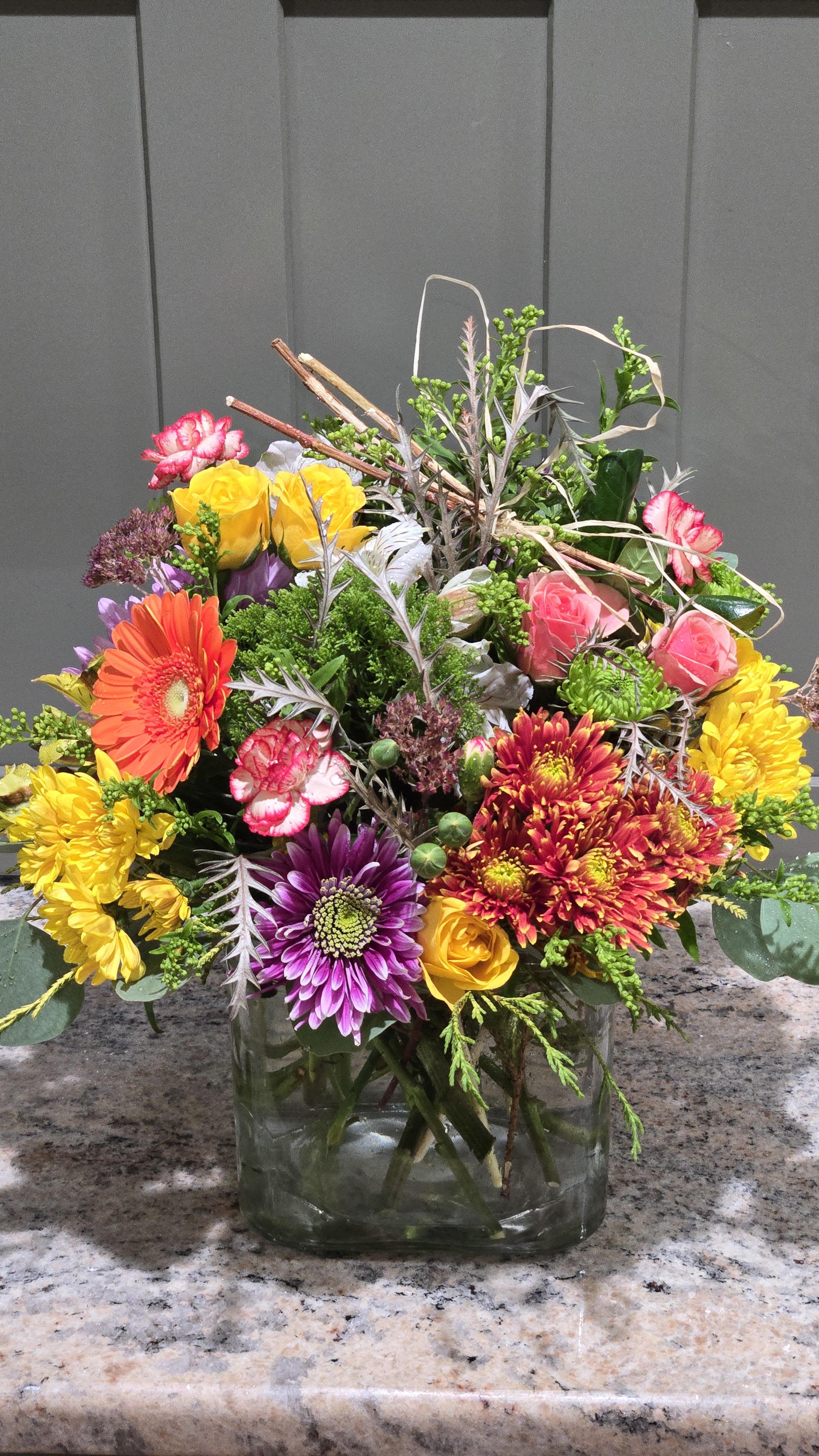 Bounty Bold Blooms - A sample photo for style and color theme! Bold color theme with nice variety of flowers. Festive for a Thanksgiving dinner party, table-scape, buffet or kitchen Island.  ONE OF A KIND Design style as shown for standard choice. Can offer more holiday Festive with deluxe or premium choice.