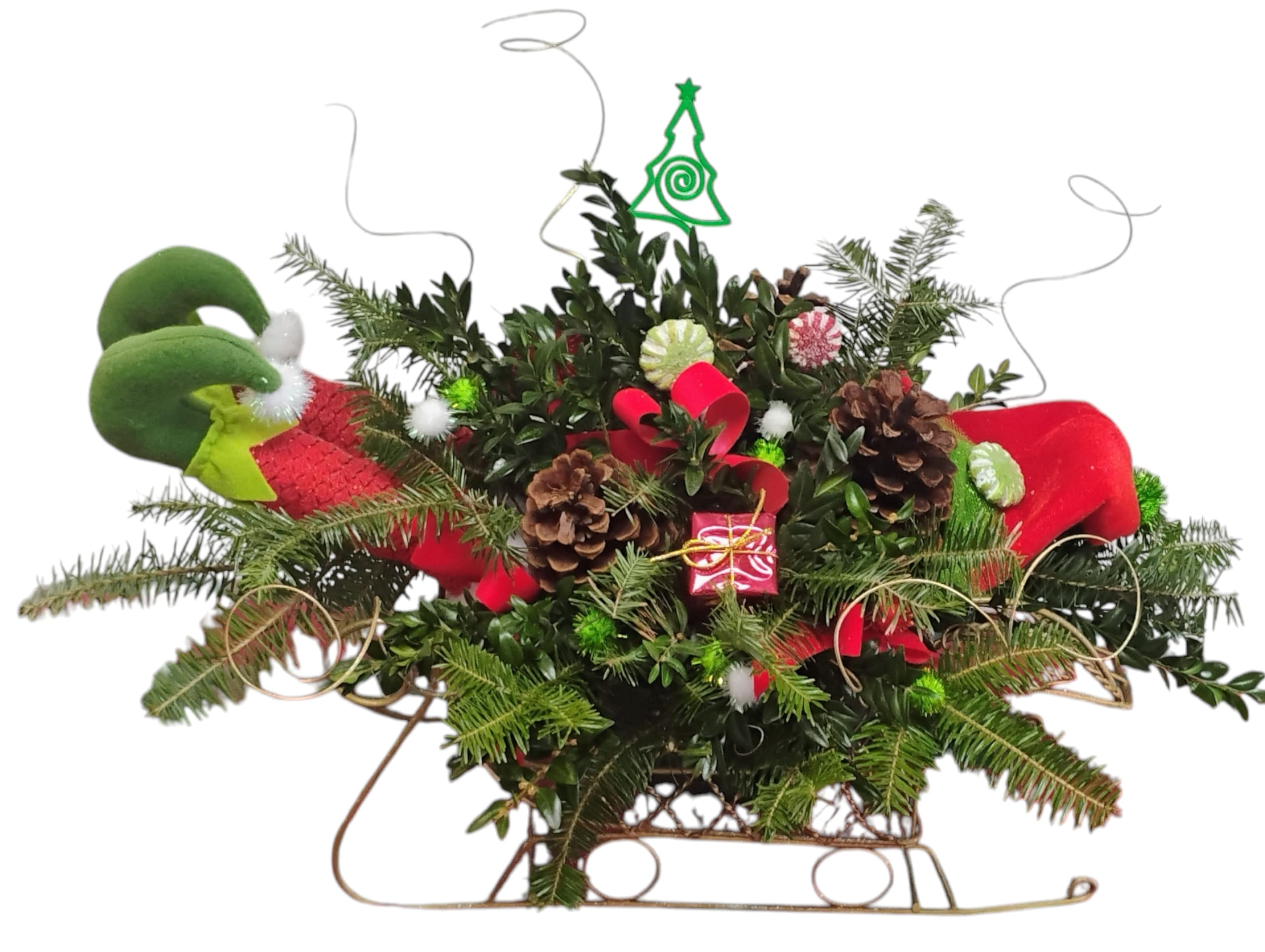 Yuletide Slumber Sleigh - A sleepy elf, a golden sleigh, and a swirl of fresh evergreen magic. This whimsical holiday arrangement features lush seasonal greens—pine, boxwood, and festive flair—tucked into an adorable sleigh with plush elf legs peeking out like he’s dozed off mid-decorating. Adorned with pinecones and decor, it’s the perfect centerpiece for cozy gatherings, boutique displays, or gifting with a wink.  