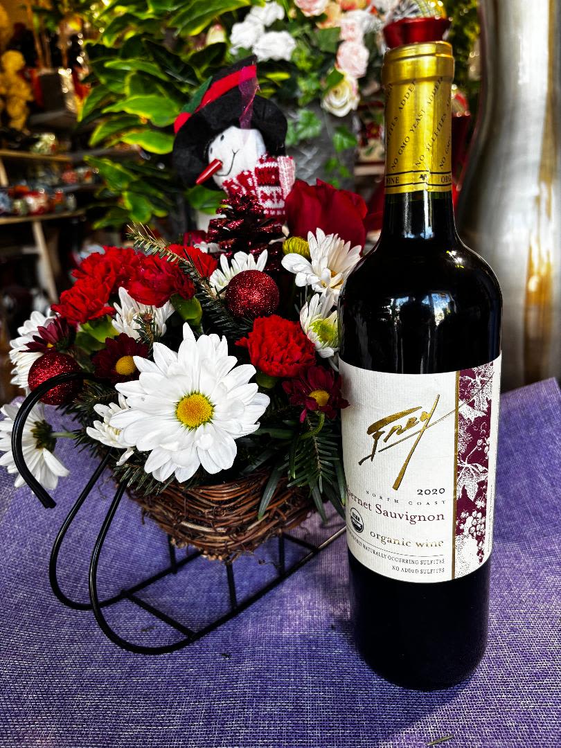 Christmas sled delivery - flowers arranged in sled keepsake with choice of red or white wine