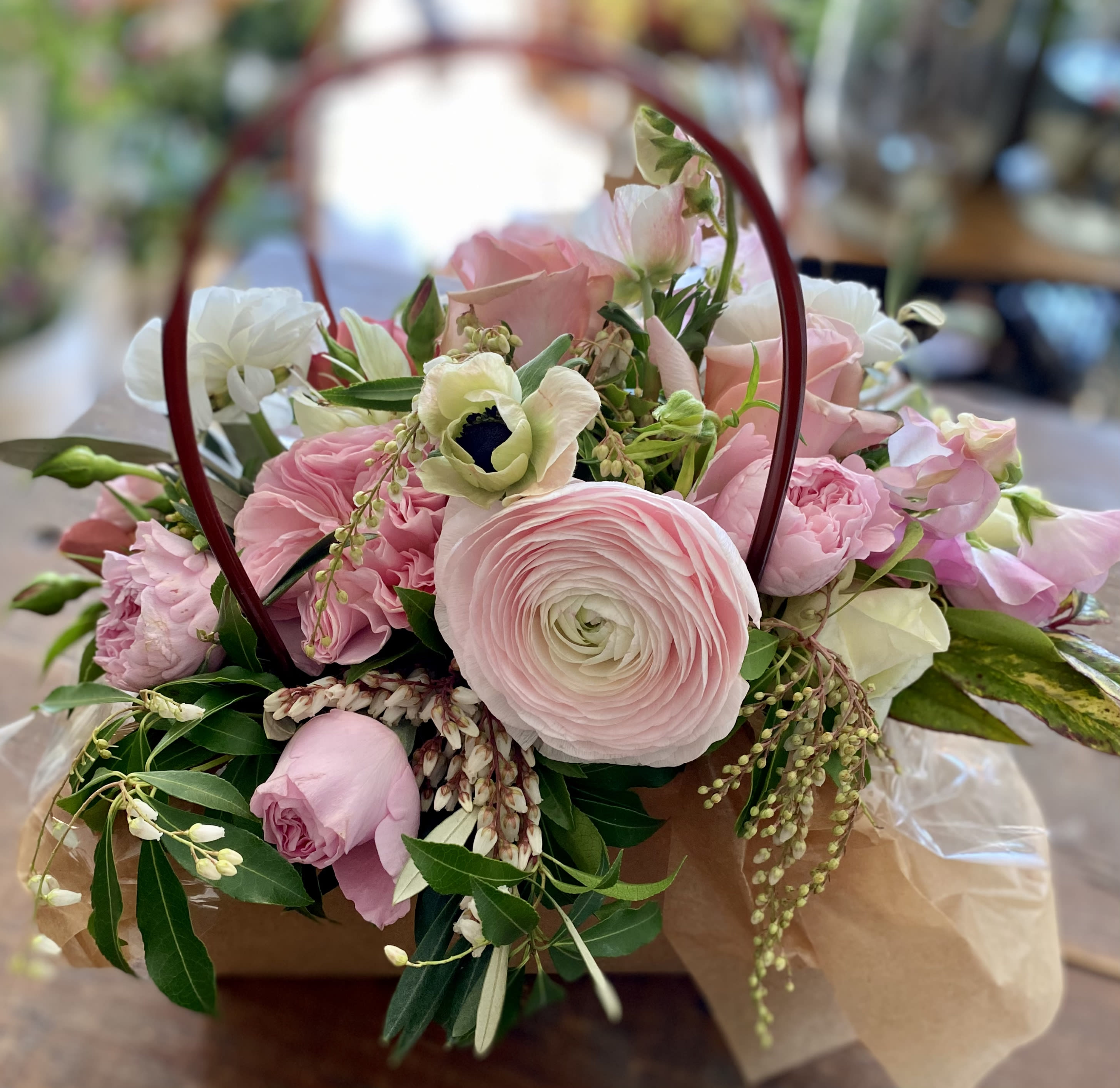 The "We Did It!" Basket - Things have been tough. We can see the light at the end of the tunnel. We made it through. Time for the "We Did It!" basket. It's on your table. Or beside your bed. Or happily waiting on your windowsill. The "We Did It!" arrangement at Momo's Flowers and More announces itself with a profusion of pinks and other happy hues bursting out of an"oasis" in a craft basket, "We Did It!" boasts various Ranunculi, Anenomes and Roses along with a few surprises along the way.