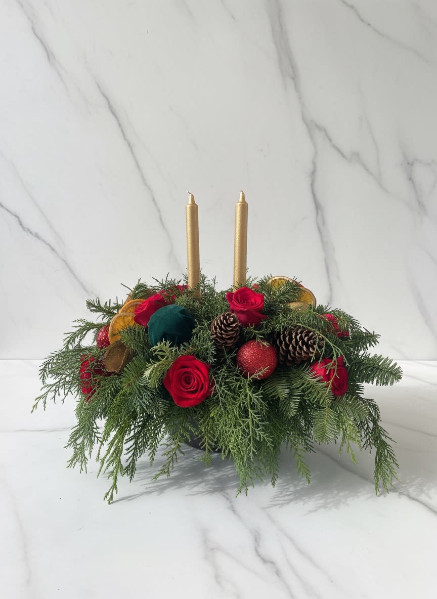 Christmas wishes - Elegant. Lovely. Radiant. This beautiful Christmas centerpiece is everything you could wish for and more.  Stunning red and white roses, white spray roses and chrysanthemums plus all of your holiday favorites like pinecones, berries, holly, Christmas greenery and two tall-tapered candles. A brilliant way to send your Christmas wishes in style. 