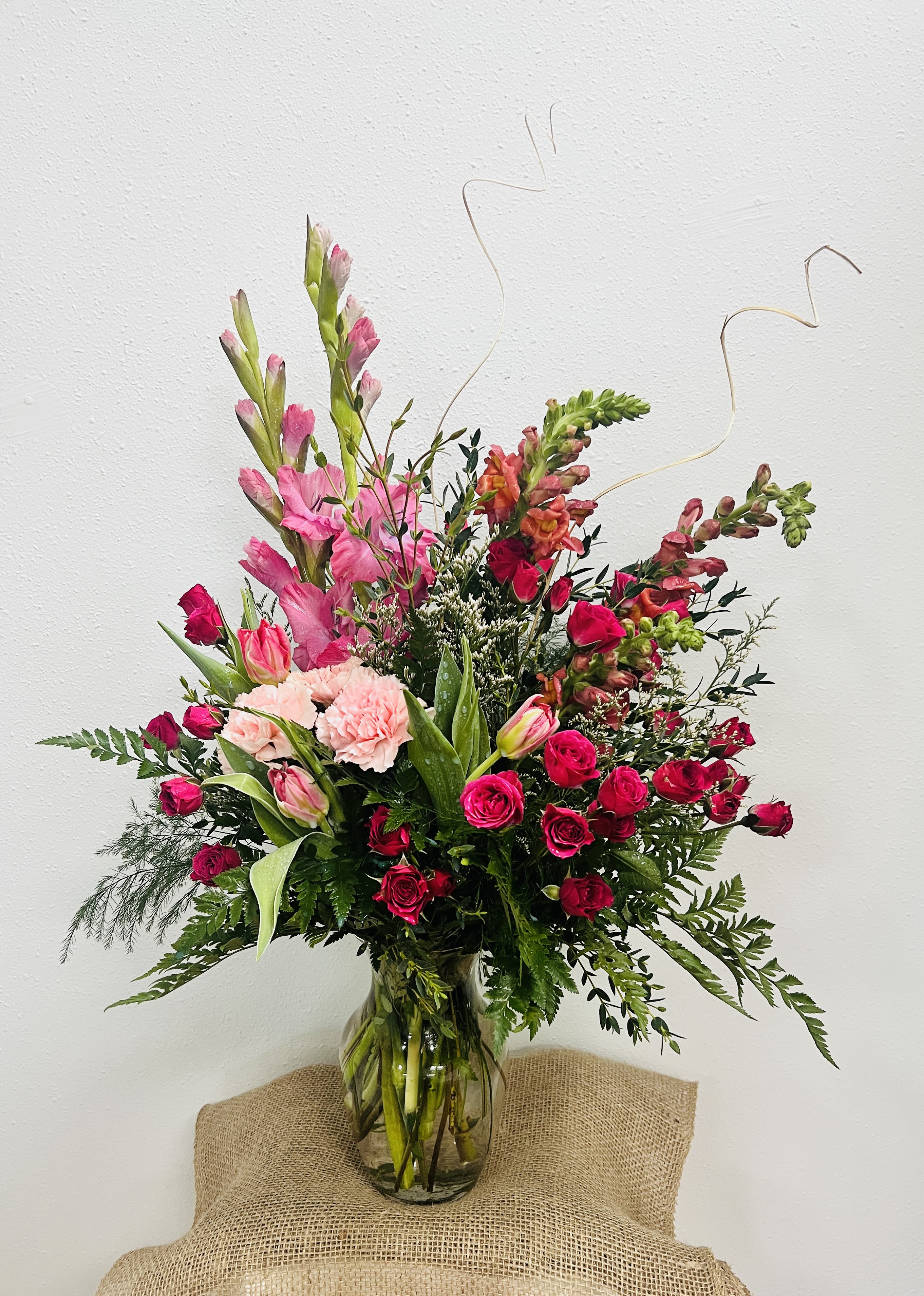 Well Wishes - Fresh-picked as if from an English garden, this uplifting vase bouquet features roses, celosia, liatris, iris, hydrangea and more.