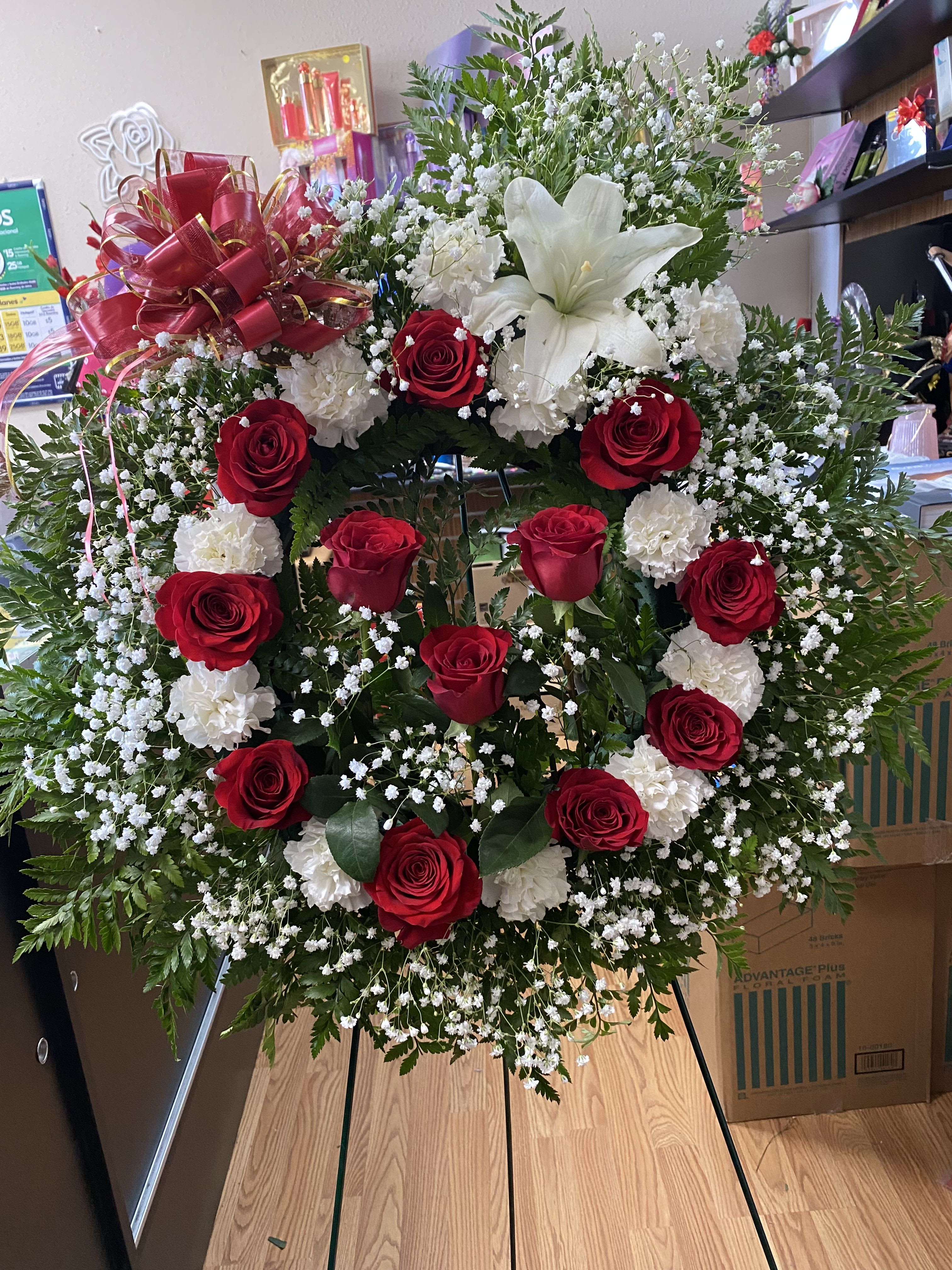 Crown for Funeral - 12 Roses, 12 carnation deluxe , baby breath , premium lily . greenery, Ruscus Israeli, and leather . 