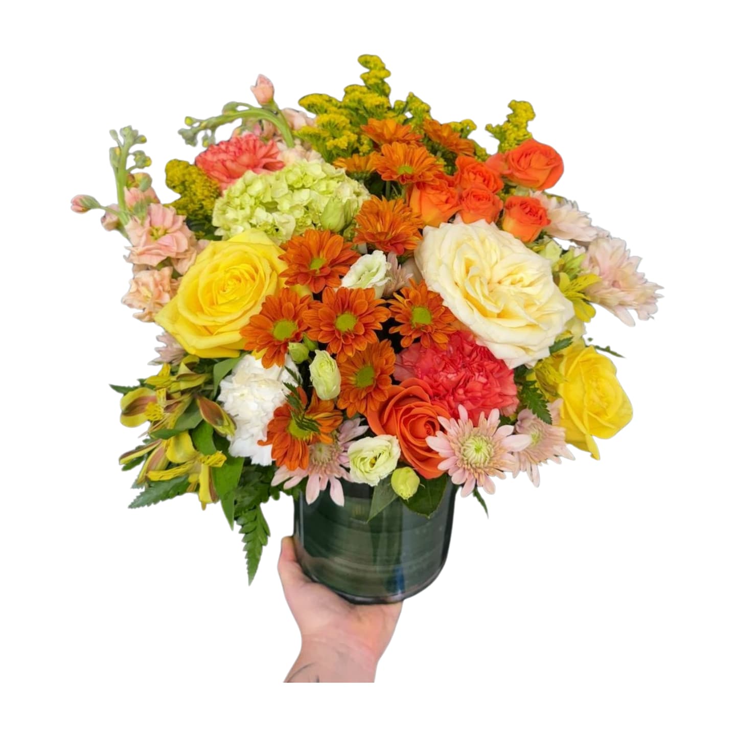 Warm Harvest - A cozy, cheerful arrangement that feels like sunshine and fall blended together. Designed with yellow roses, peach spray roses, orange mums, hydrangea, alstroemeria, carnations, and soft greenery in a modern green glass vase. Perfect as a gift, table centerpiece, or “just because you deserve flowers” moment.