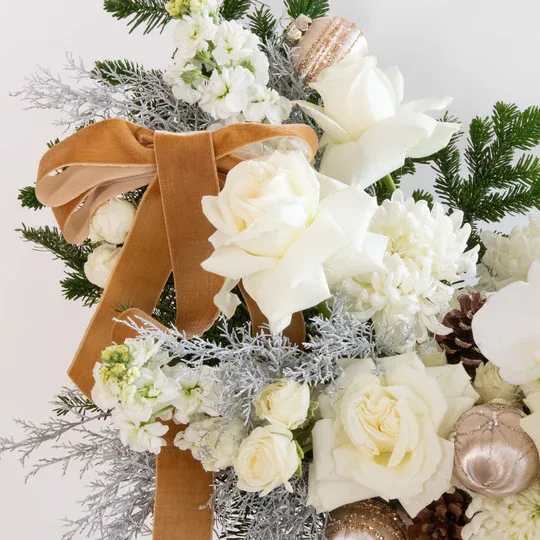 WINTER WHITE DESIGNER’S CHOICE - An elegant seasonal arrangement designed in soft winter whites with premium fresh blooms such as roses, stock, spray roses, mums, pine, and holiday accents. Styled with velvet ribbon and winter textures, each arrangement is crafted uniquely based on the freshest stems of the day.  Clean, timeless, and perfect for holiday gifting, winter celebrations, or a serene décor moment in the home.  Each design varies in shape and floral selection, created in the Studio C Florals winter aesthetic.
