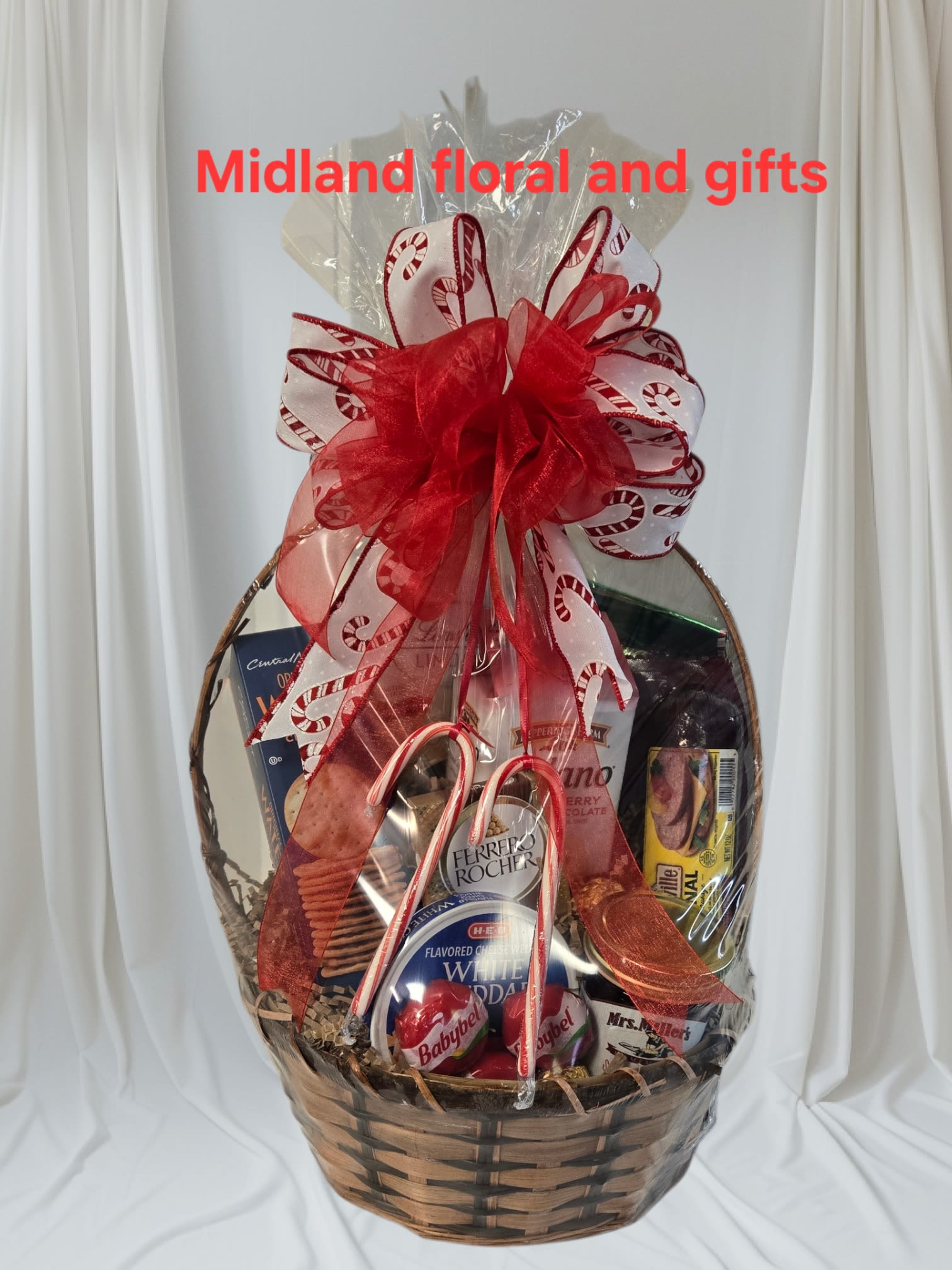 Gourmet basket  - cheeses,3 baby bell cheese, sausage, crackers, Pepperidge Farm cookies, 2 bagsDove, 3 Rocher Chocolates, jelly block of ferrero chocolate. 