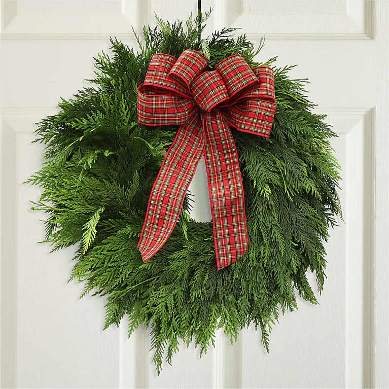 Christmas Wreath with Red Plaid Bow - CHRISTMAS WREATH WITH RED PLAID BOW  Bring warmth and joy of the holidays to your front door with this festive wreath. The wreath is made of Western Red Cedar and decorated with a traditional plaid ribbon.
