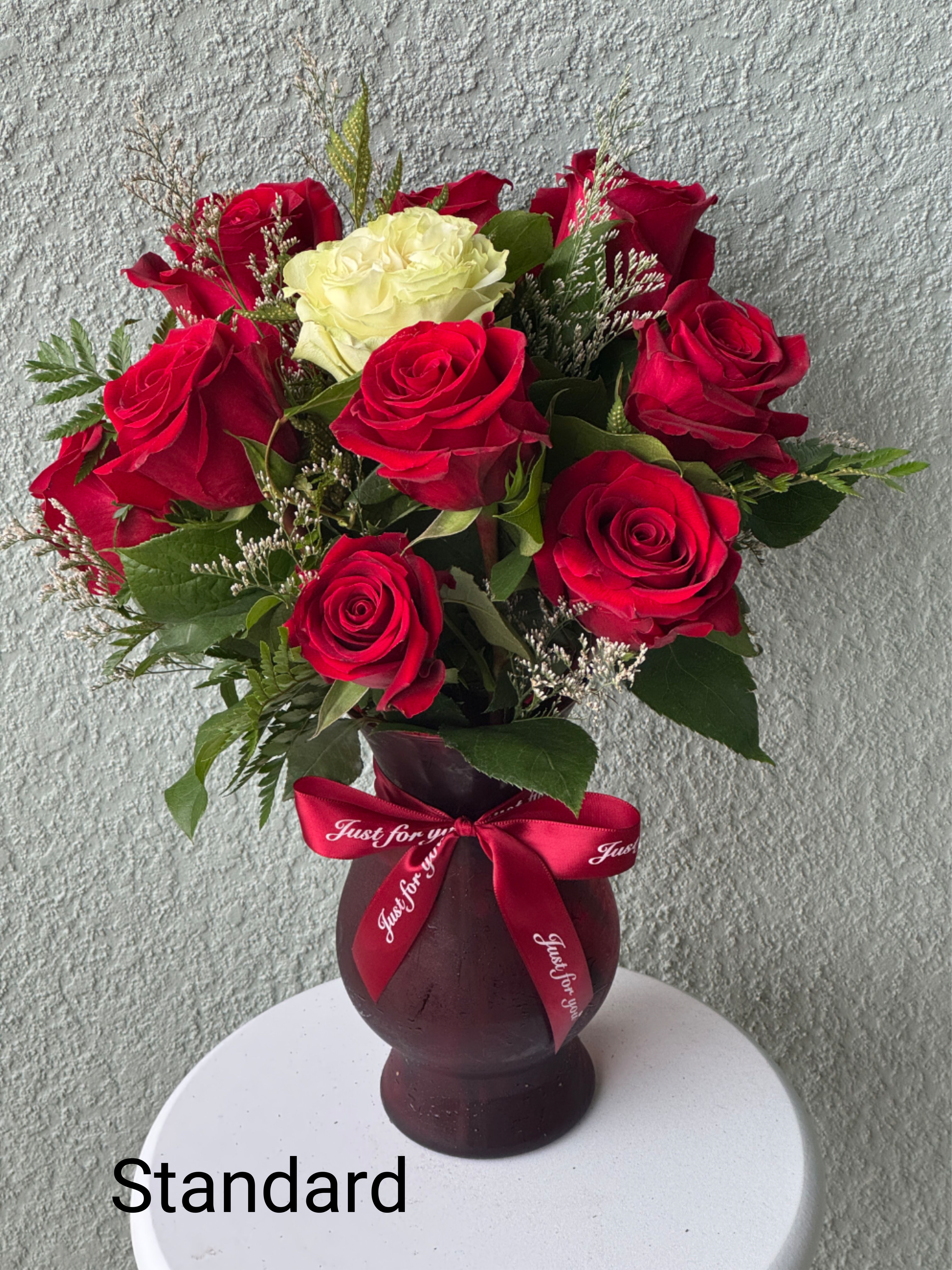 Signature Dozen Roses - Our Signature Dozen Red Roses is the ultimate symbol of love and passion. Featuring twelve long-stemmed, premium red roses arranged with rich greenery in an elegant glass vase, this luxurious bouquet is designed to leave a lasting impression. Each rose is carefully placed for balance and beauty, making it a perfect gift for anniversaries, romantic gestures, or any moment you want.  When order please let us know what color do you want unless you want to keep it as is.