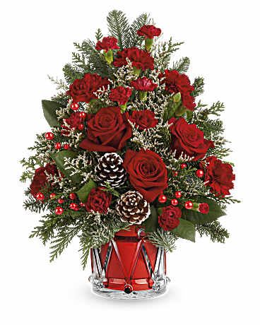 Yuletide Sparkle Tree - Our  Yuletide Sparkle Tree is a festive floral Christmas tree made of red blooms, holiday greens, and shimmering accents. Arranged in keepsake Crystal Drum Vase, it's a joyful holiday gift or centerpiece. This flowers red roses, red carnations, and red miniature carnations. Accented with white limonium, cedar, noble fir, pinecones, and berries in Teleflora's Crystal Drum Vase  Orientation: All-Around   SUBSTITUTION POLICY Always deliver the freshest flowers! Please note the bouquet pictured reflects our original design.  If the exact flowers or container in this arrangement are not available, our local florists will create a beautiful bouquet with the freshest available flowers.
