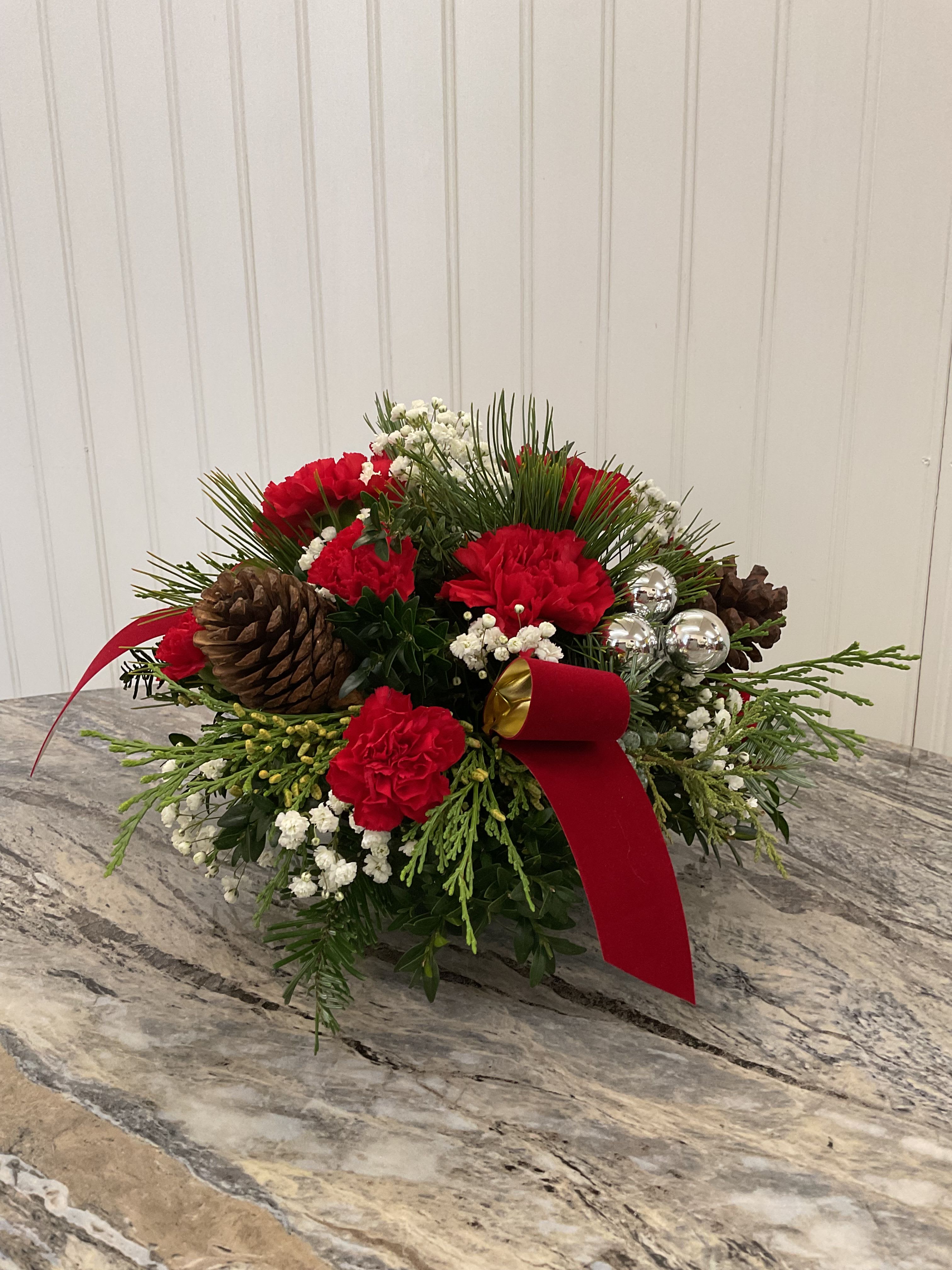 Round X-mas Centerpiece - Perfect for the center of your Christmas Feast. Each arrangement is filled with Christmas greenery and decorated to match the beautiful holiday among us.