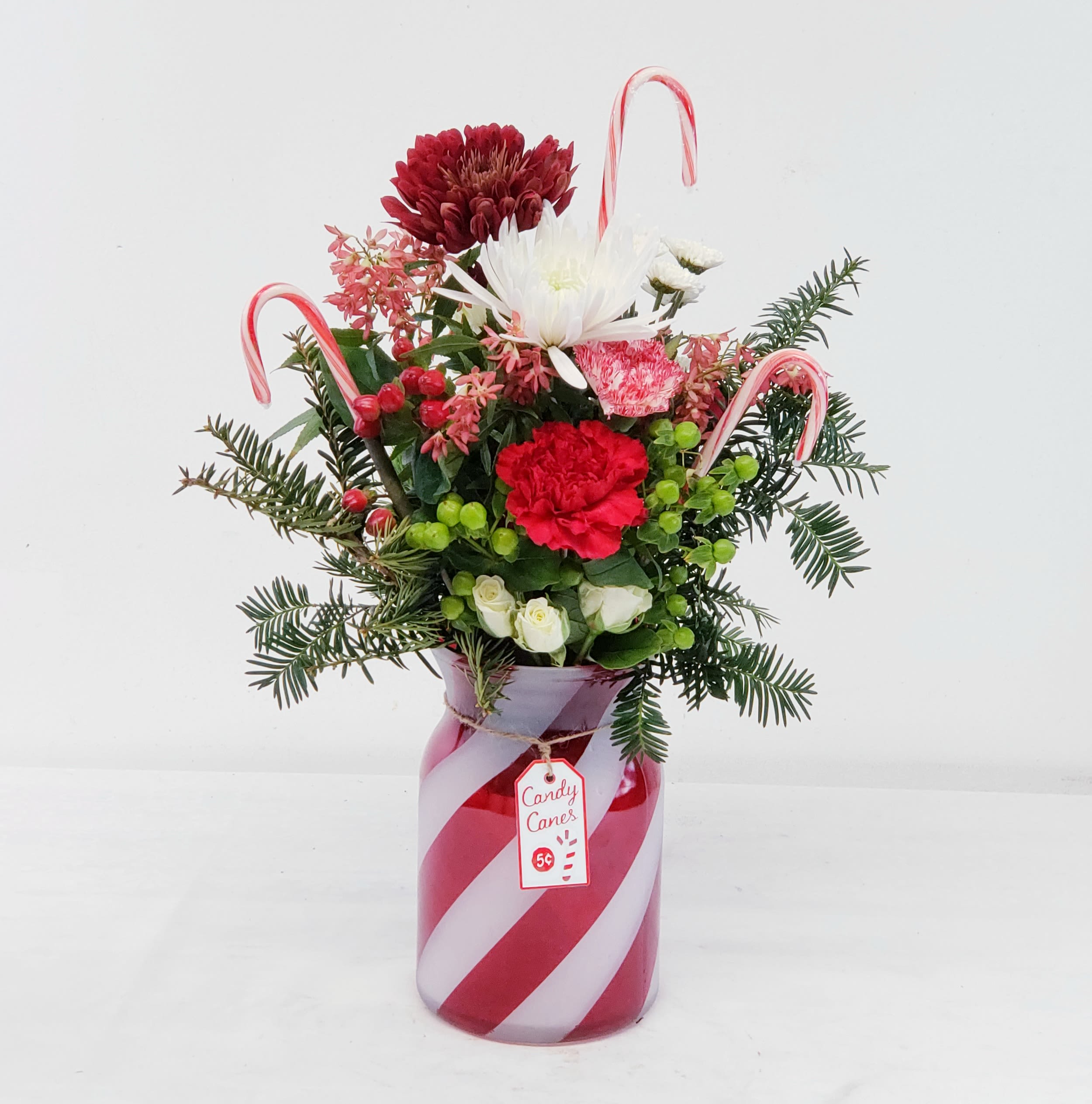 Candy Cane Lane - A delicious bouquet bursting with holiday spirit! Approximate overall height 24", in an 8" striped, frosted vase. Makes a wonderful gift to celebrate the season!